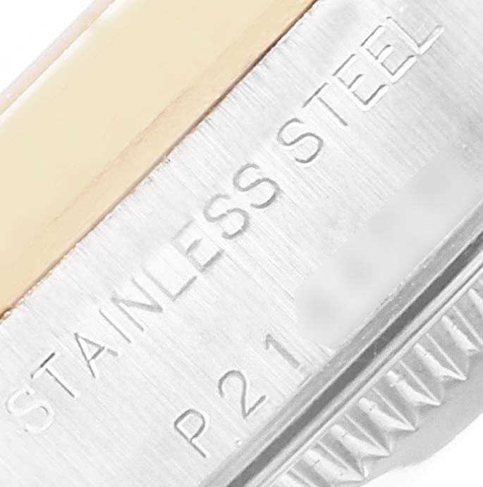 This close-up image shows the side of the stainless steel case of a Rolex Oyster Perpetual 76193 Women
s Steel and Gold (two tone) Champagne Dial 76193 Women
s Steel and Gold (two tone) Champagne Dial watch, including part of the bezel.