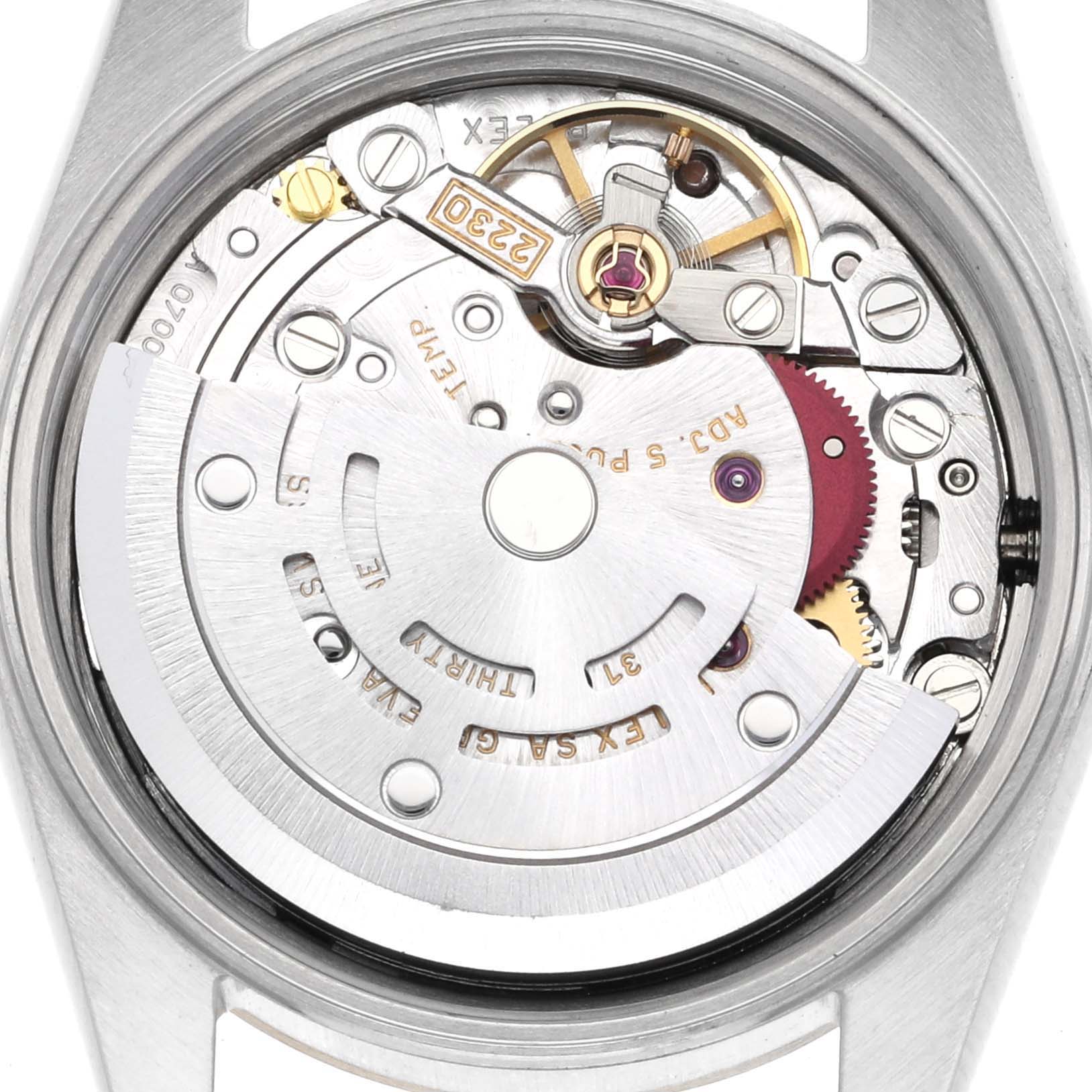 The image shows the internal mechanism of a Rolex Oyster Perpetual 76183 Women's Steel and Gold (two tone) Silver Dial 76183 Women's Steel and Gold (two tone) Silver Dial watch, highlighting the rotor and intricate movement parts.