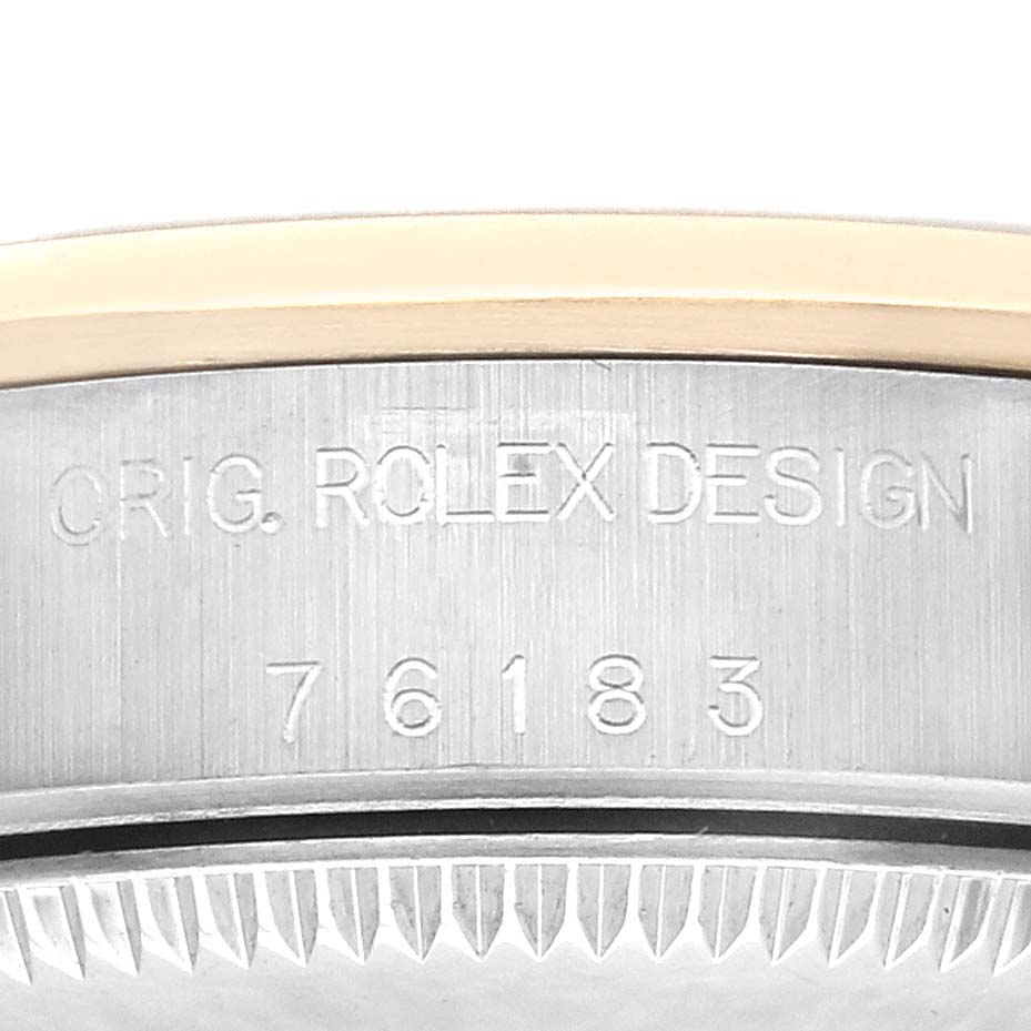The image shows a close-up of the case side of a Rolex Oyster Perpetual 76183 Women's Steel and Gold (two tone) Silver Dial 76183 Women's Steel and Gold (two tone) Silver Dial, highlighting the engraved model number.