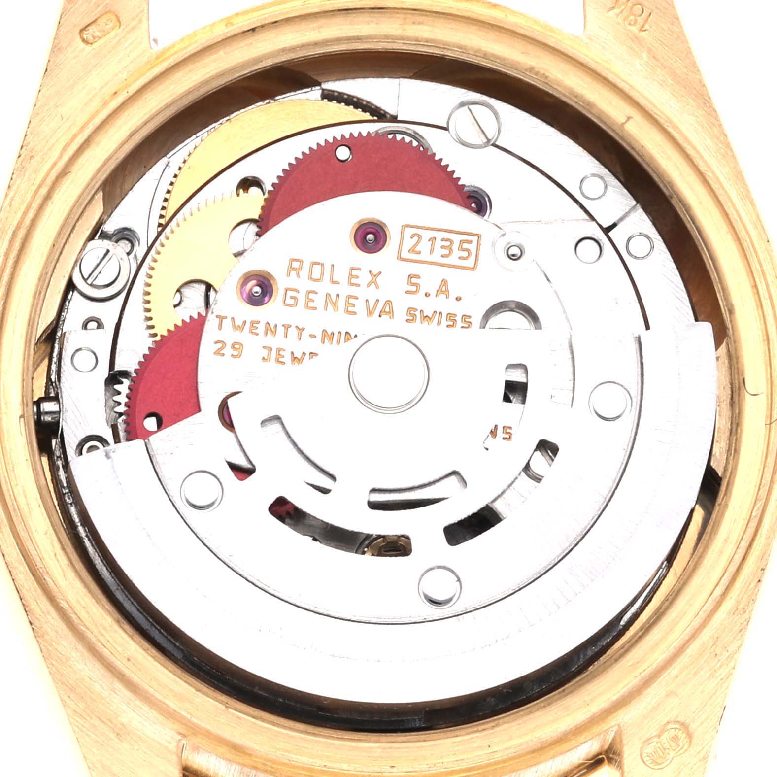The image shows the movement mechanism of a Rolex President 69138 Women's Yellow Gold White Dial 69138 Women's Yellow Gold White Dial model, featuring gears and inscriptions.