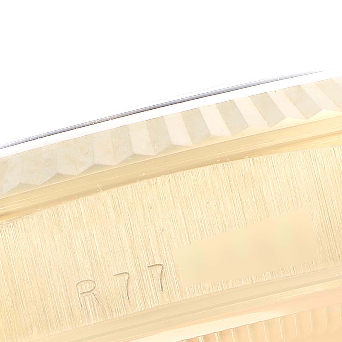 The image shows a close-up of the serial number engraving and fluted bezel of a Rolex President 18238 Men's Yellow Gold Black Dial 18238 Men's Yellow Gold Black Dial model watch.