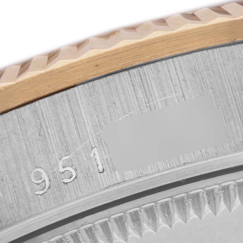The image shows a close-up of the fluted bezel and side of a Rolex President 68279 Women's White Gold Pink Dial 68279 Women's White Gold Pink Dial watch, capturing part of the engravings.