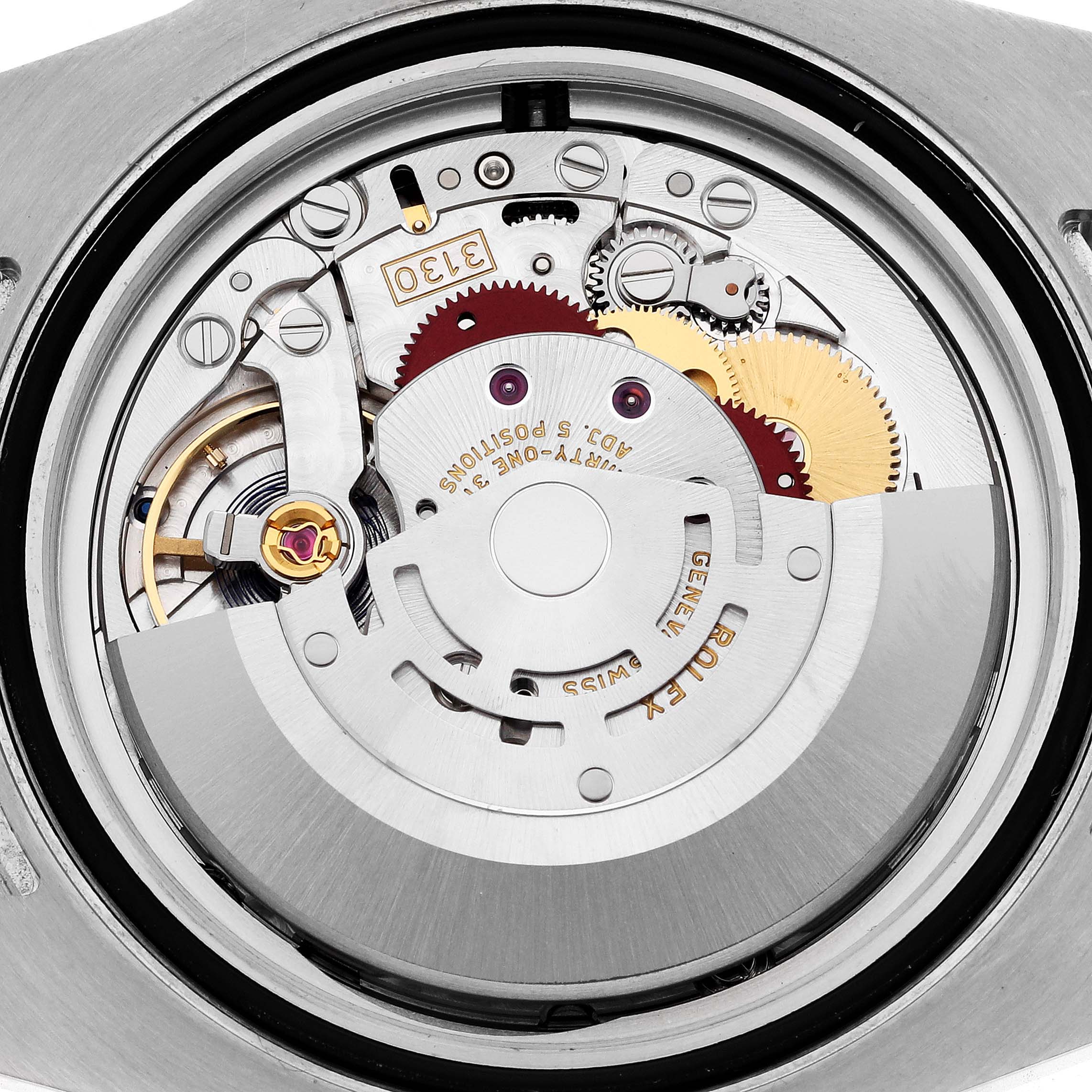 The image shows the movement of a Rolex Submariner 114060 Men's Stainless Steel Black Dial 114060 Men's Stainless Steel Black Dial watch from a top-down angle, highlighting its intricate mechanical parts.