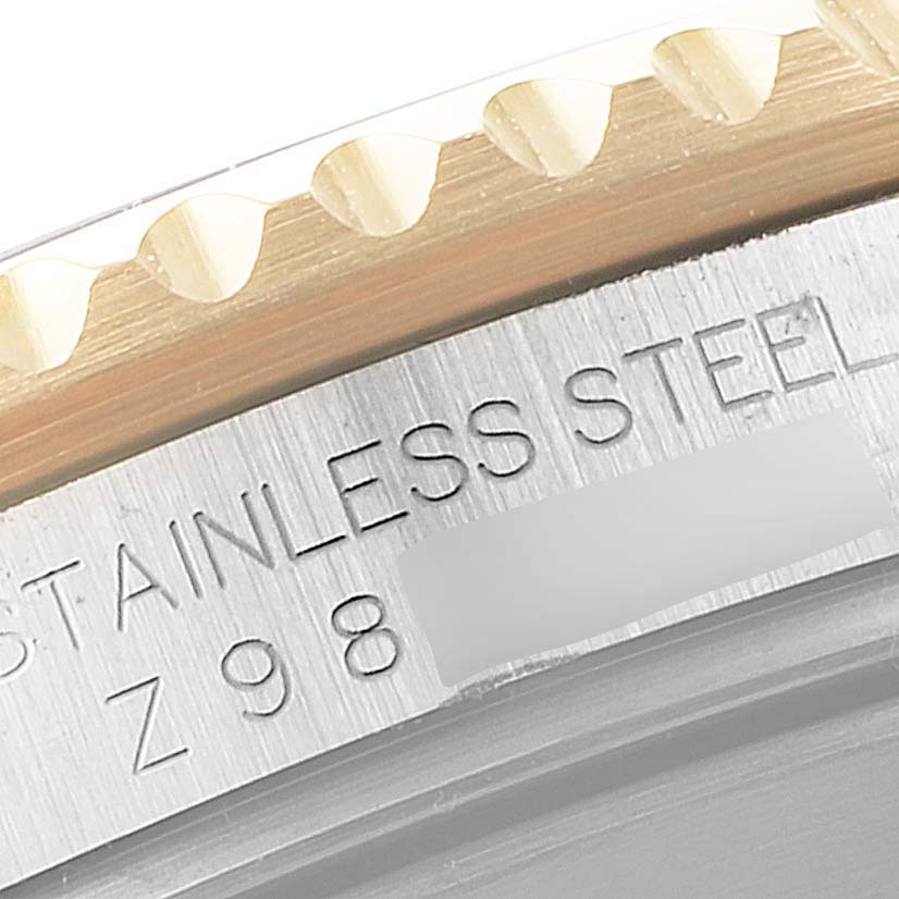 This image shows a close-up of the Rolex Submariner 16613 Men
s Steel and Gold (two tone) Grey Dial 16613 Men
s Steel and Gold (two tone) Grey Dial
s bezel and stainless steel case engraving.