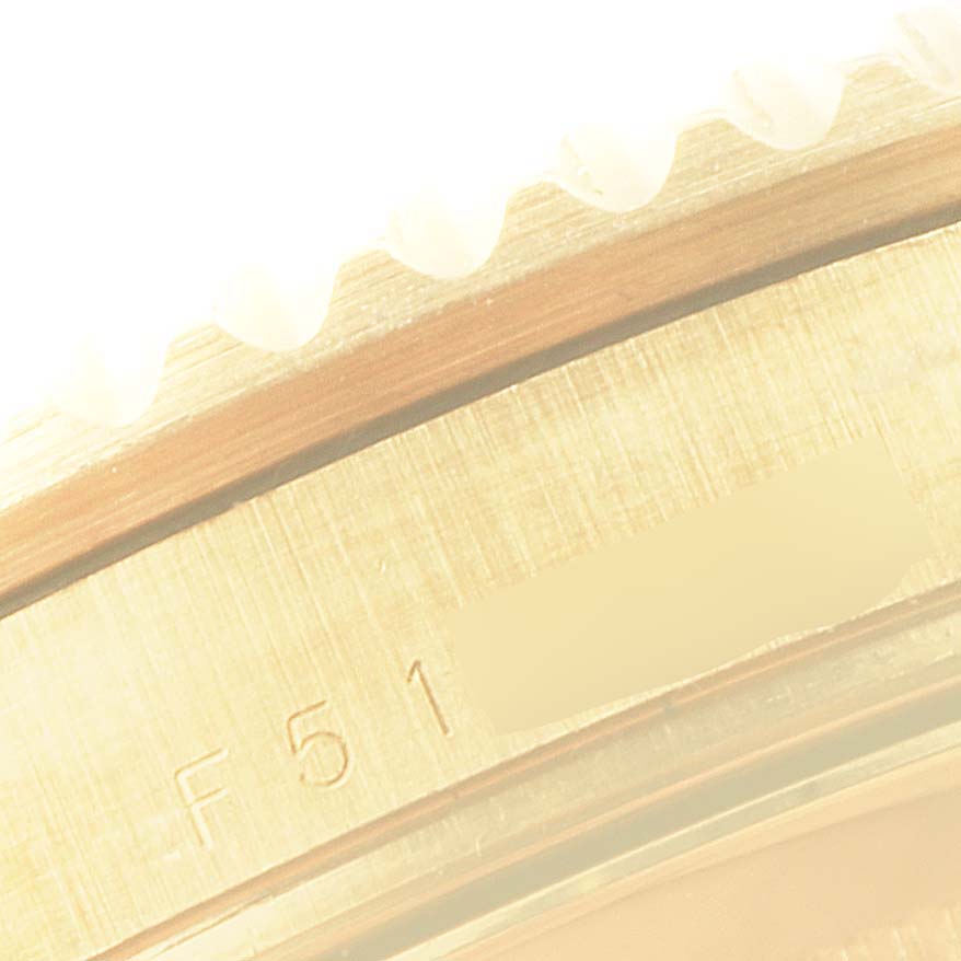 This image shows a close-up of the bezel and edge of the case of a Rolex Submariner 16618 Men's Yellow Gold Grey Dial 16618 Men's Yellow Gold Grey Dial watch.