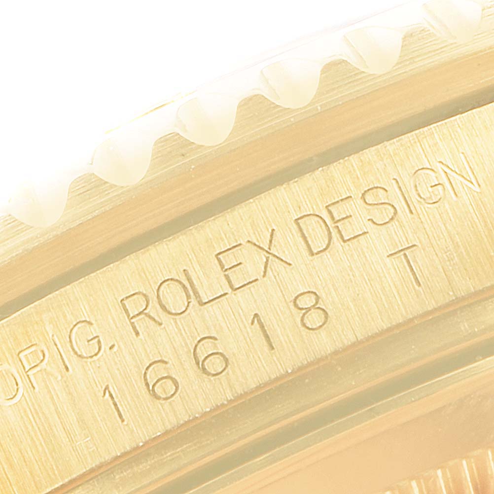 Close-up of the side engraving on a Rolex Submariner 16618 Men's Yellow Gold Grey Dial 16618 Men's Yellow Gold Grey Dial, showing the bezel and "Rolex Design" text.
