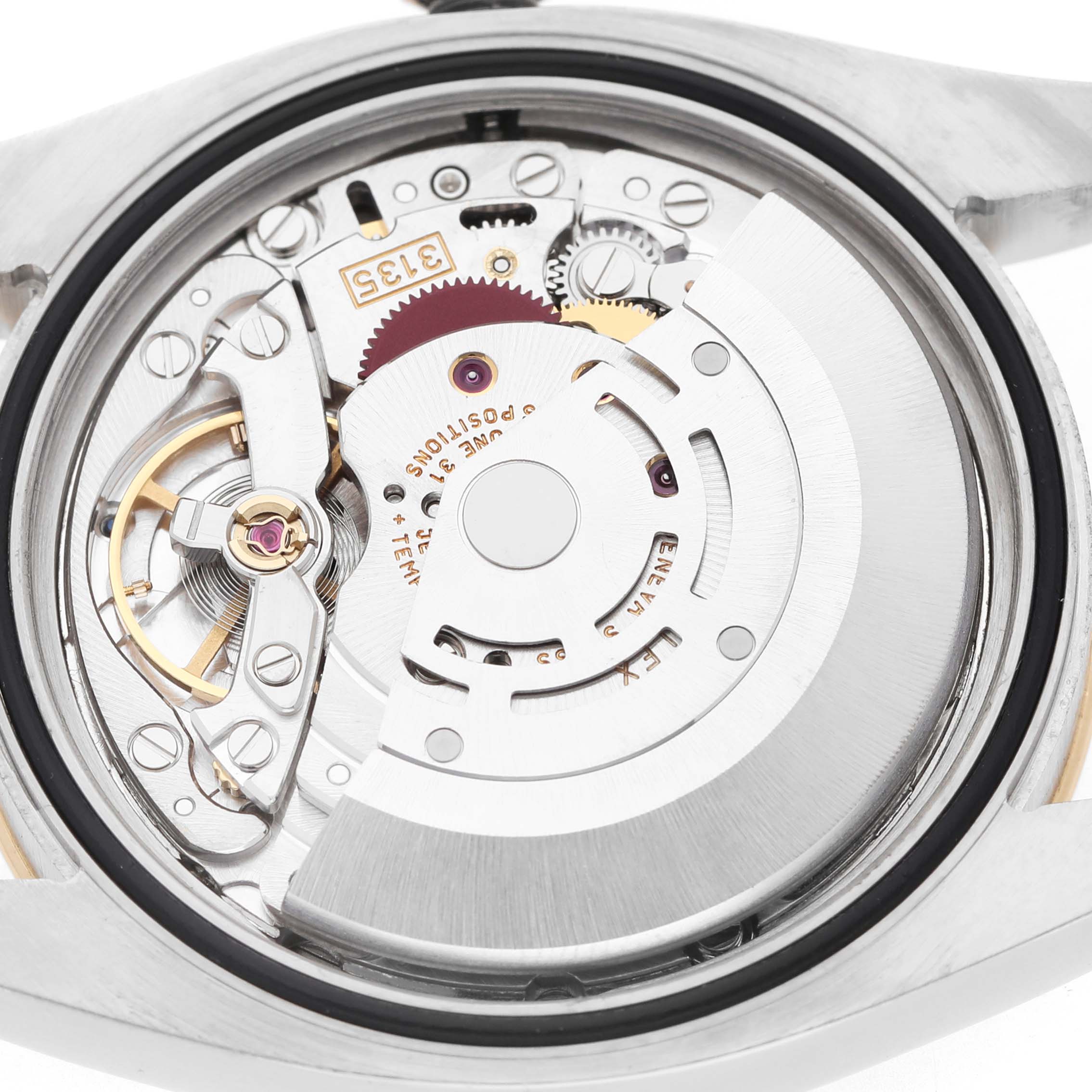 The image shows the movement of the Rolex Turn-o-Graph 116263 Men's Steel and Gold (two tone) Grey Dial watch from a rear angle, revealing gears and rotor.