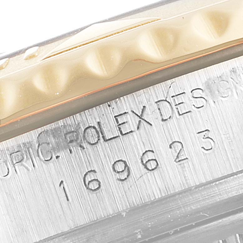 The image shows an extreme close-up of the Rolex Yacht-Master 169623 Women's Steel and Gold (two tone) Mother of Pearl Dial 169623 Women's Steel and Gold (two tone) Mother of Pearl Dial model's bezel and case, highlighting its serial number.