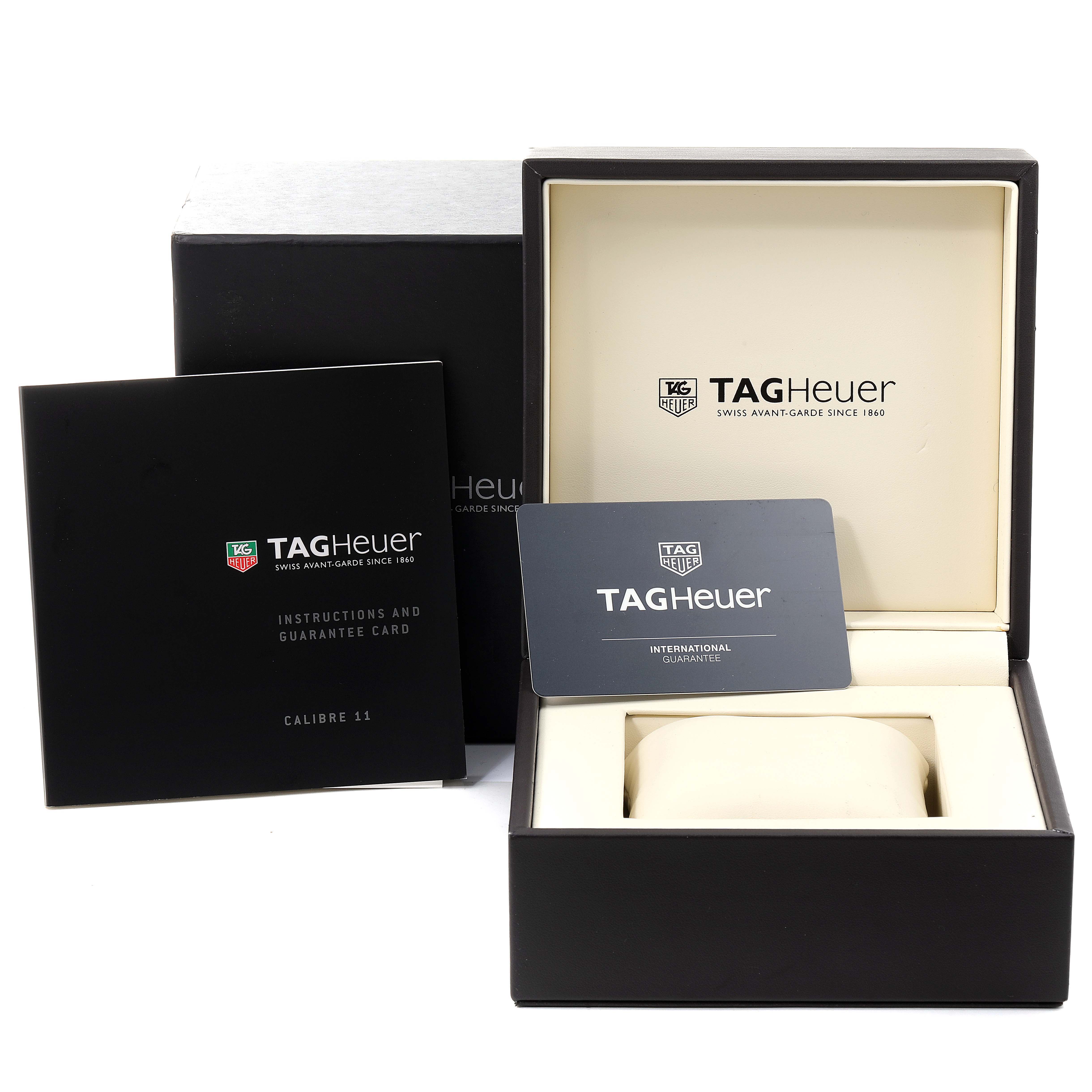 The image shows the packaging, instruction manual, and guarantee card for the Tag Heuer Monaco model watch.