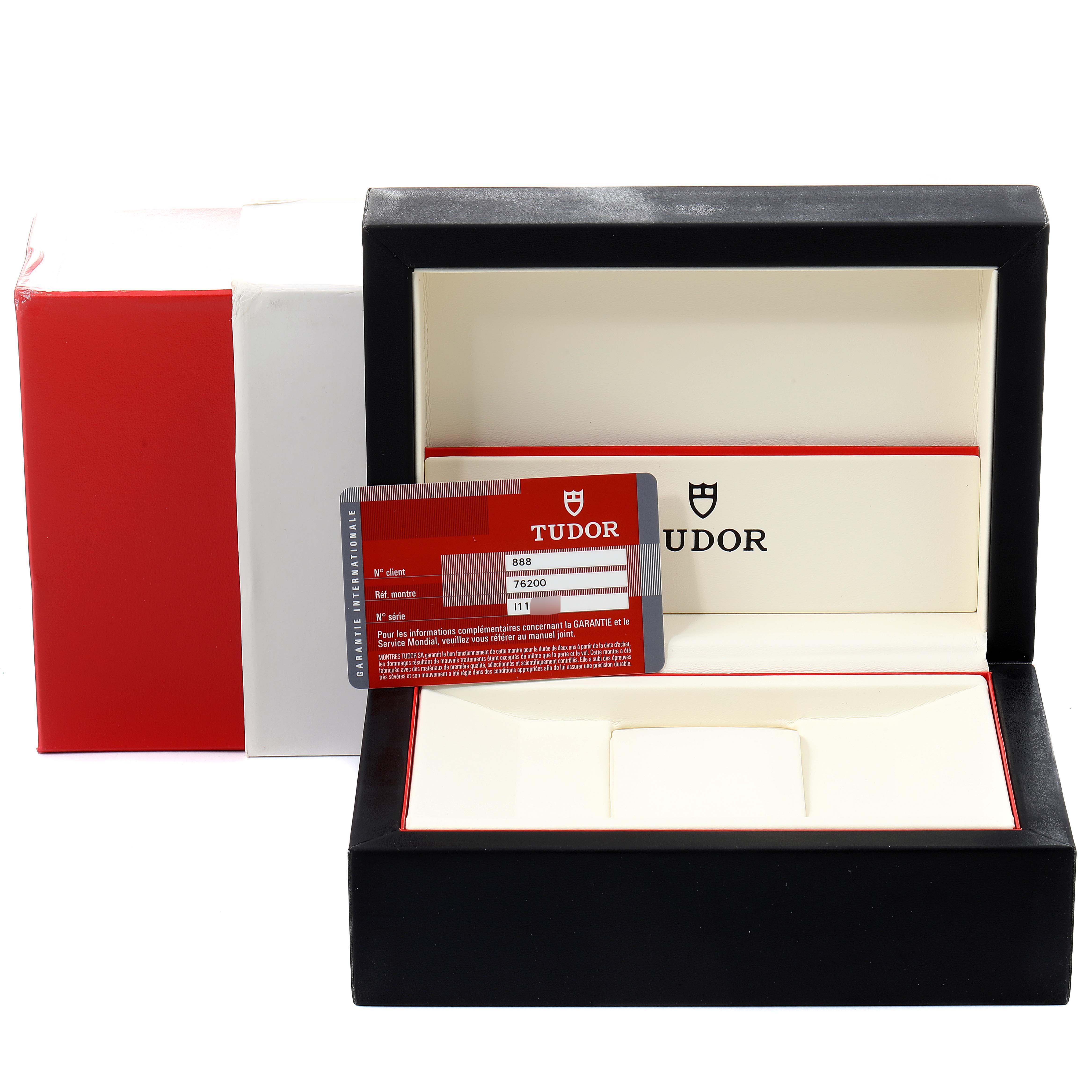 The image shows an open Tudor Prince 76200 Men
s Stainless Steel Silver Dial 76200 Men
s Stainless Steel Silver Dial watch box with a warranty card placed inside.
