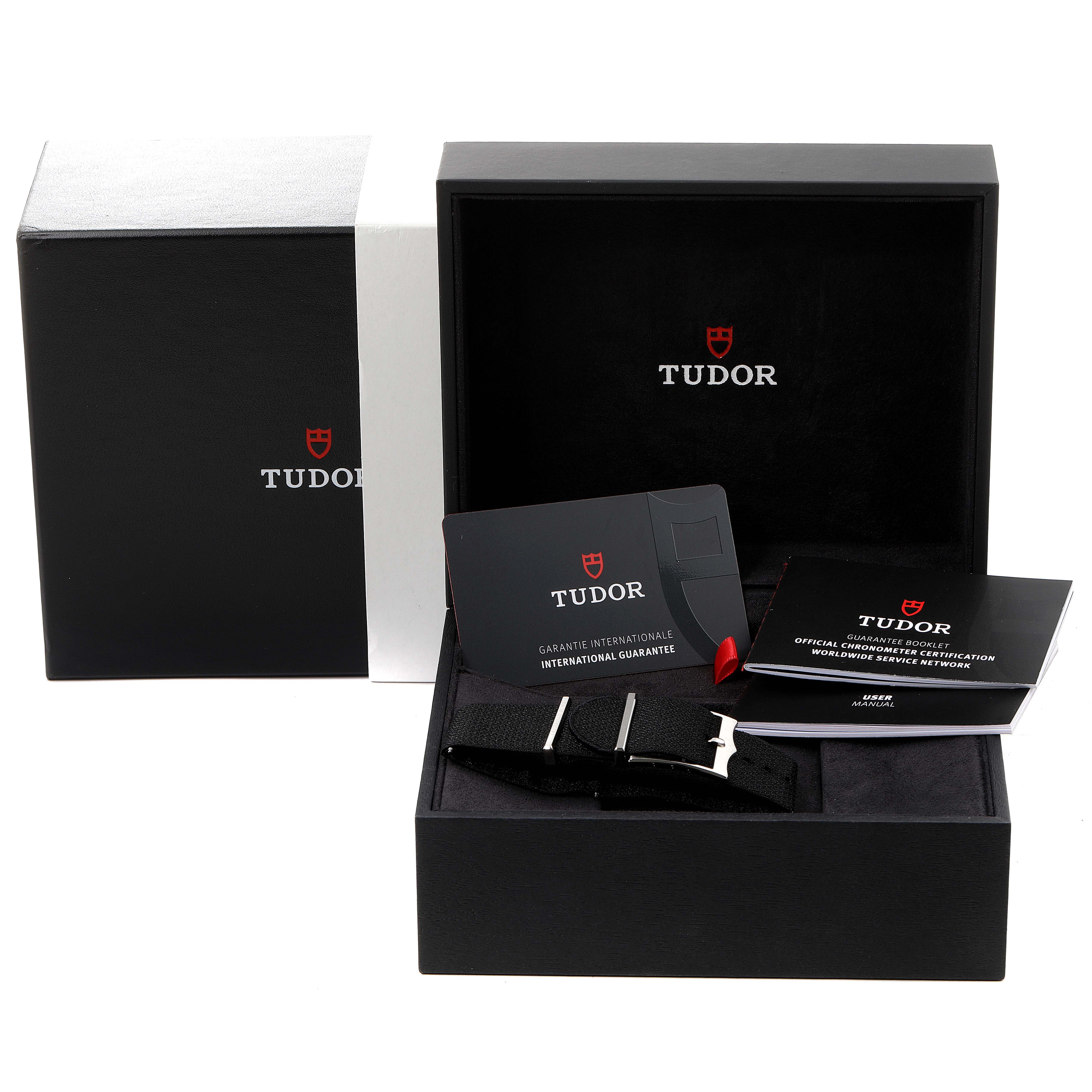 The image shows the Tudor Heritage Black Bay 79230G Men's Stainless Steel Black Dial 79230G Men's Stainless Steel Black Dial watch packaging, including warranty cards, manuals, and an additional strap.