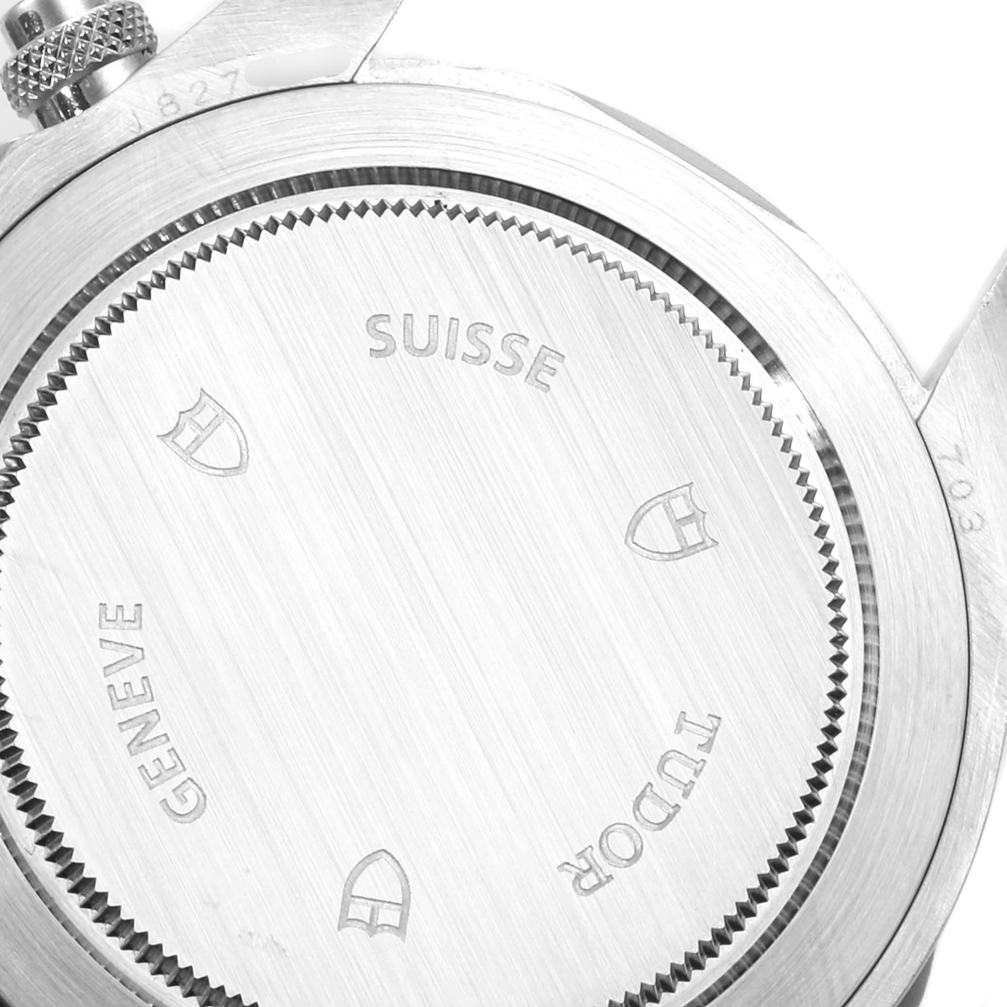 This image shows the backside of a Tudor Heritage Chrono 70330B Men's Stainless Steel Blue Dial 70330B Men's Stainless Steel Blue Dial watch, highlighting the engraved details and branding.