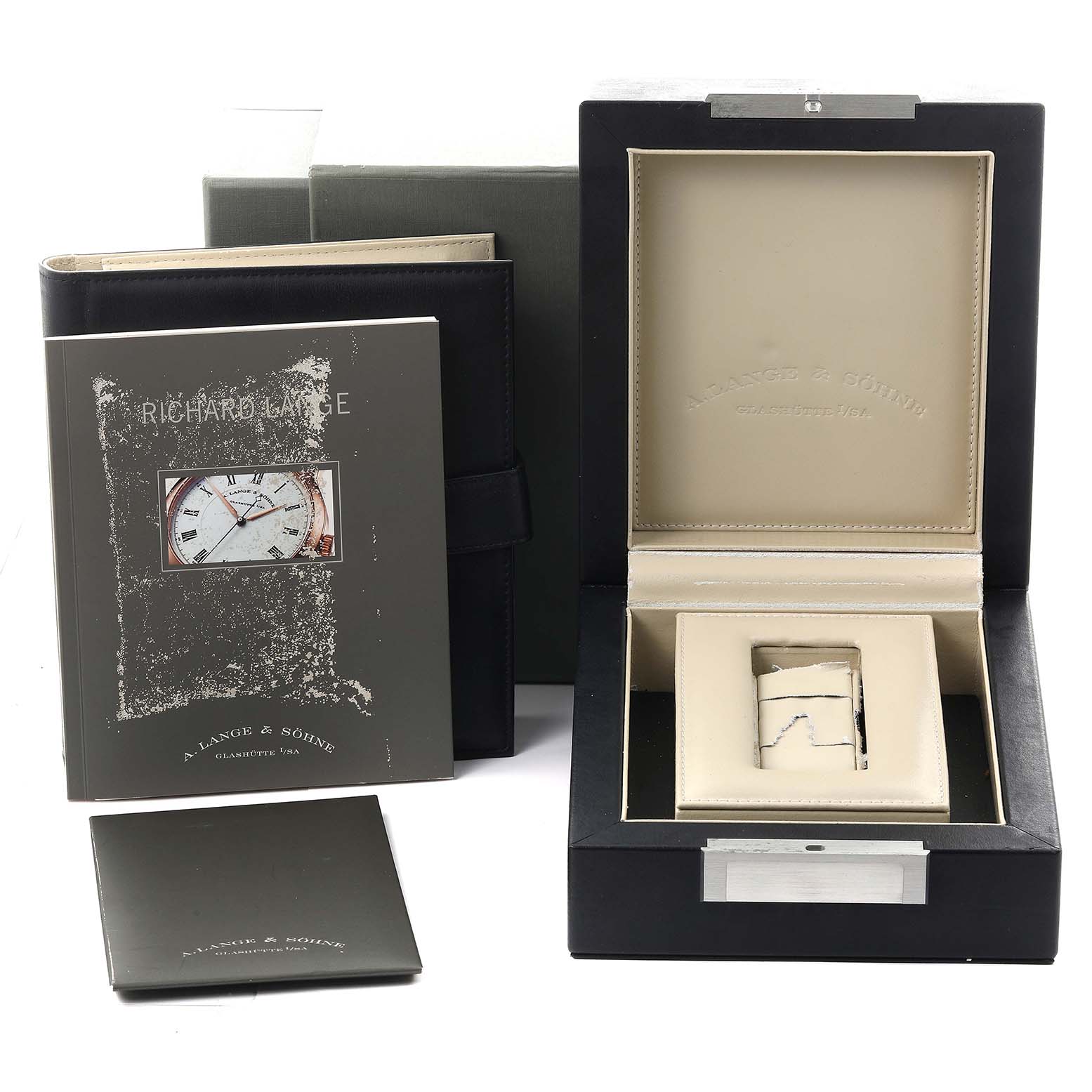 The image shows the A. Lange & Sohne Richard Lange 232.032 / LSLS2324AD Men's Rose Gold Silver Dial watch packaging, manuals, and an empty interior watch holder.