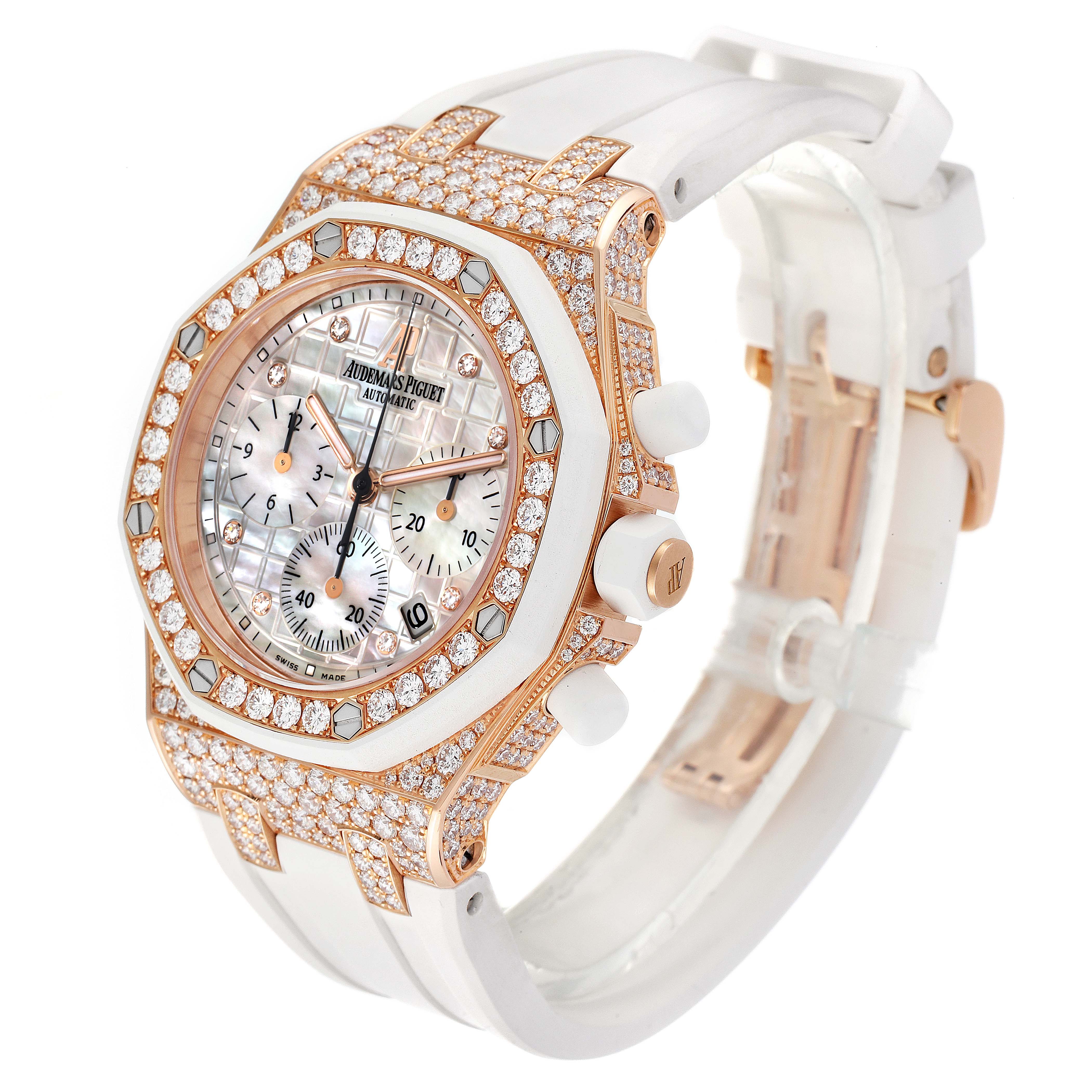 The Audemars Piguet Royal Oak Offshore 26092OK.ZZ.D010CA.01 Women
s Rose Gold Mother of Pearl Dial 26092OK.ZZ.D010CA.01 Women
s Rose Gold Mother of Pearl Dial watch is shown at a three-quarter angle, highlighting the diamond-encrusted bezel and white strap.