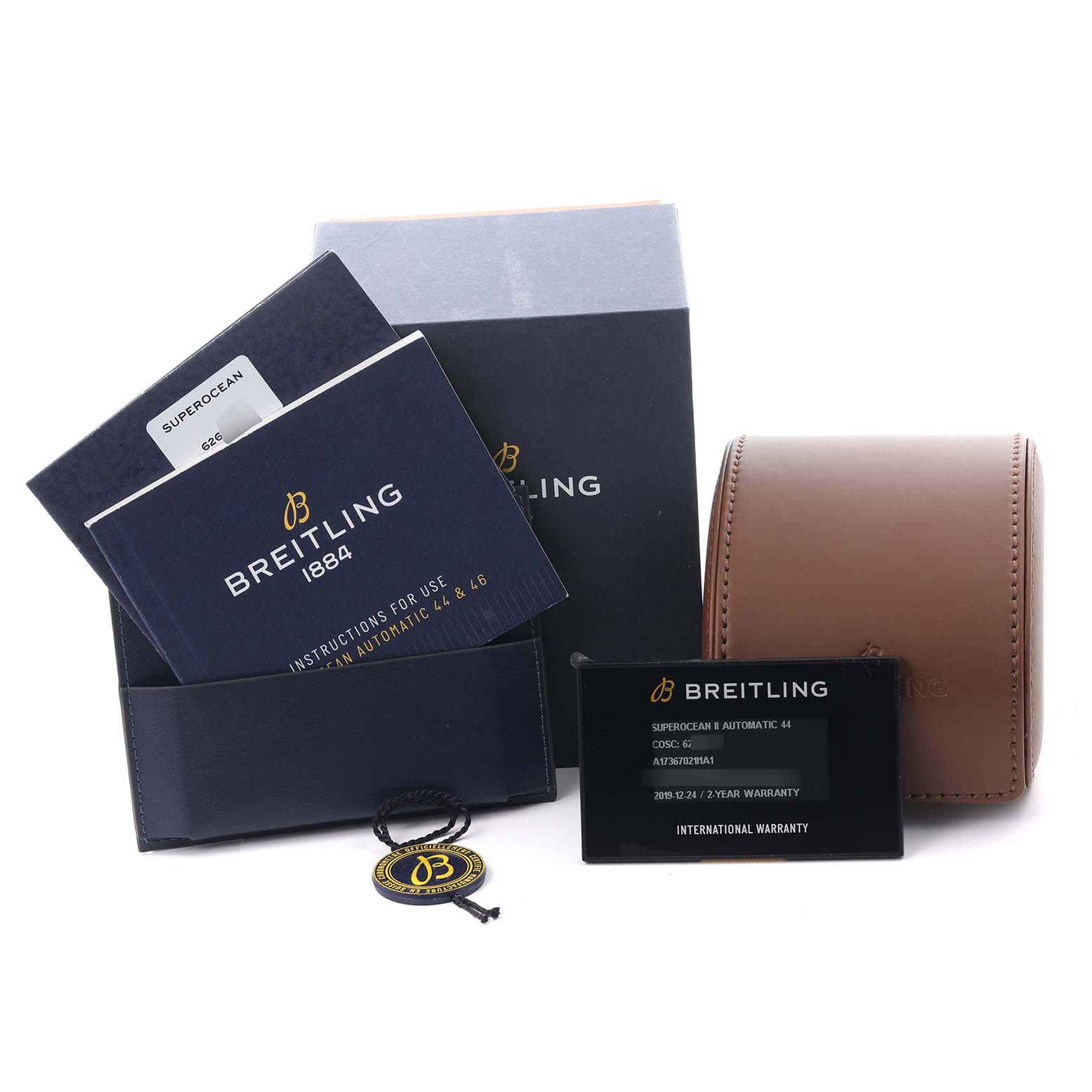 The image shows Breitling Superocean A17367021I1A1 Men's Stainless Steel Yellow Dial A17367021I1A1 Men's Stainless Steel Yellow Dial accessories: a watch box, instruction booklets, warranty card, and tag.