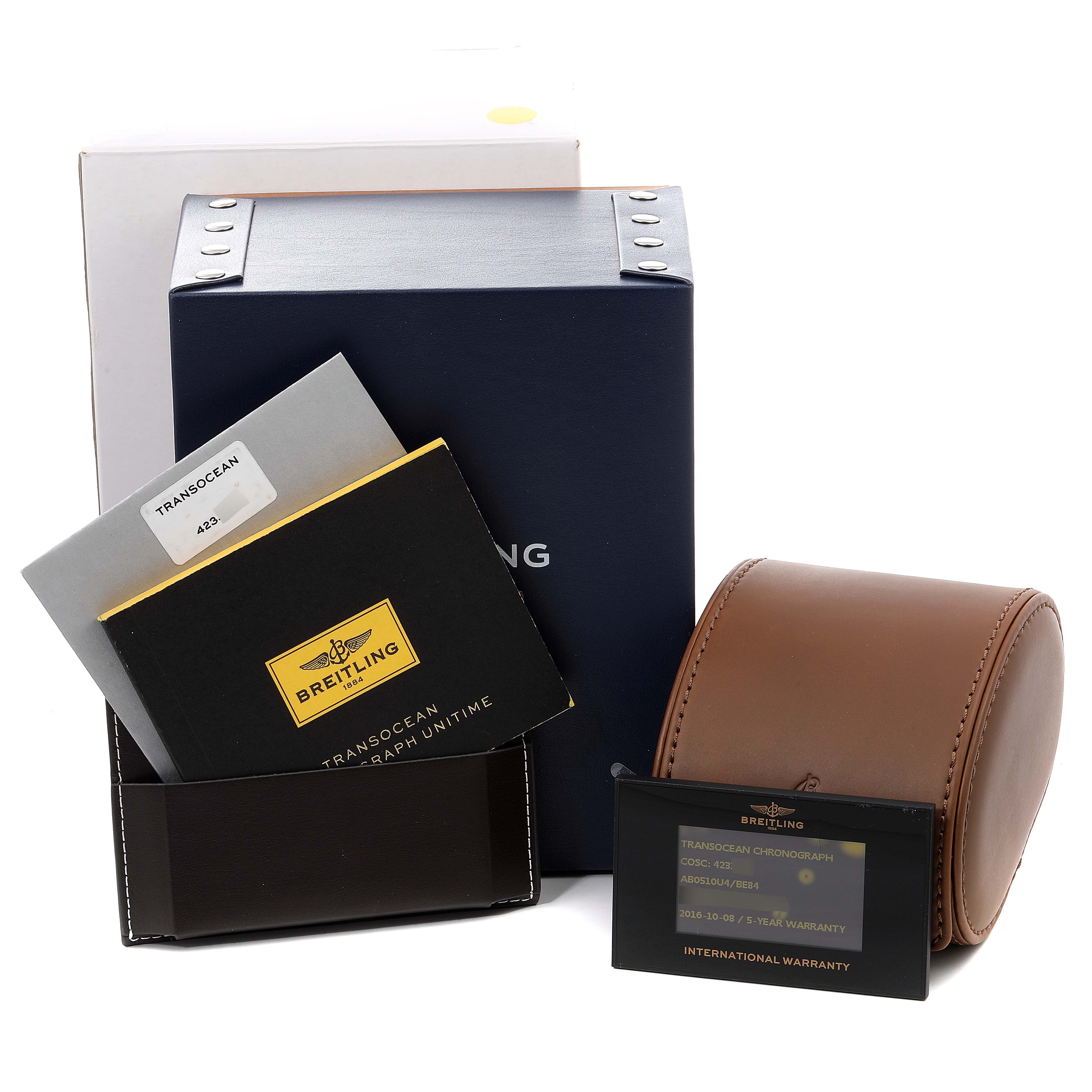 The image shows the packaging and accessory items of a Breitling Transocean AB0510 Men's Stainless Steel Black Dial AB0510 Men's Stainless Steel Black Dial model, including a box, manuals, and a warranty card.