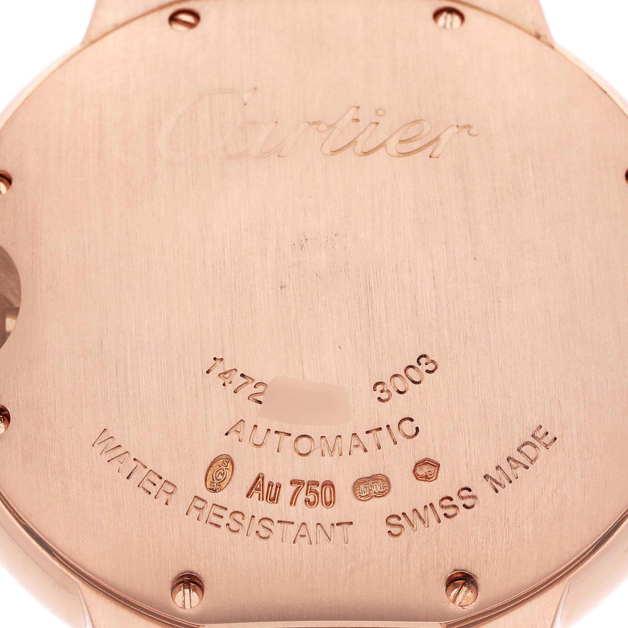 The image shows the back case of a Cartier Ballon Bleu WE9005Z3 Women
s Rose Gold Silver Dial WE9005Z3 Women
s Rose Gold Silver Dial watch from a close-up angle, detailing engravings and markings.