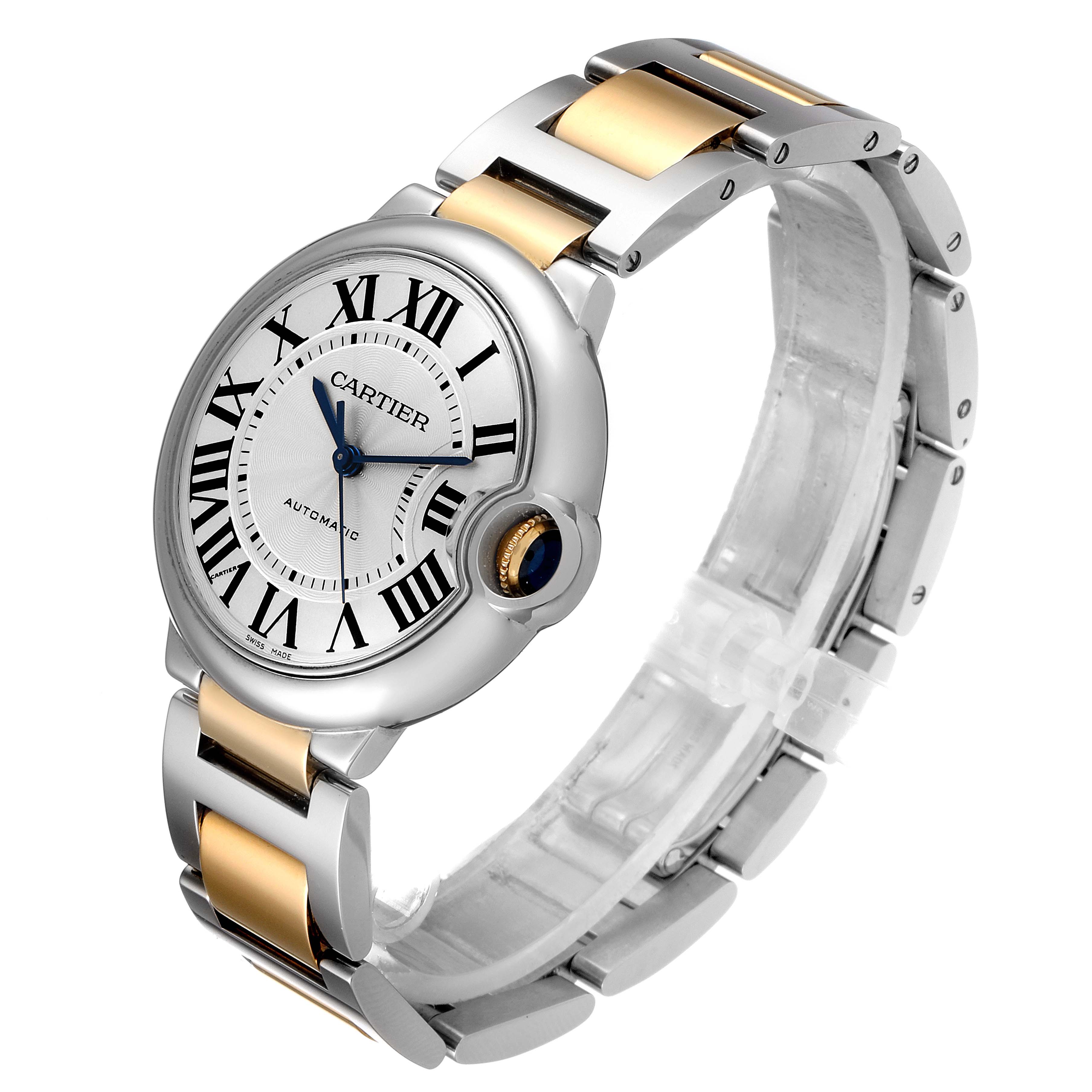 The Ballon Bleu by Cartier is shown from an angled view, displaying the dial, bracelet, and crown with a blue cabochon.