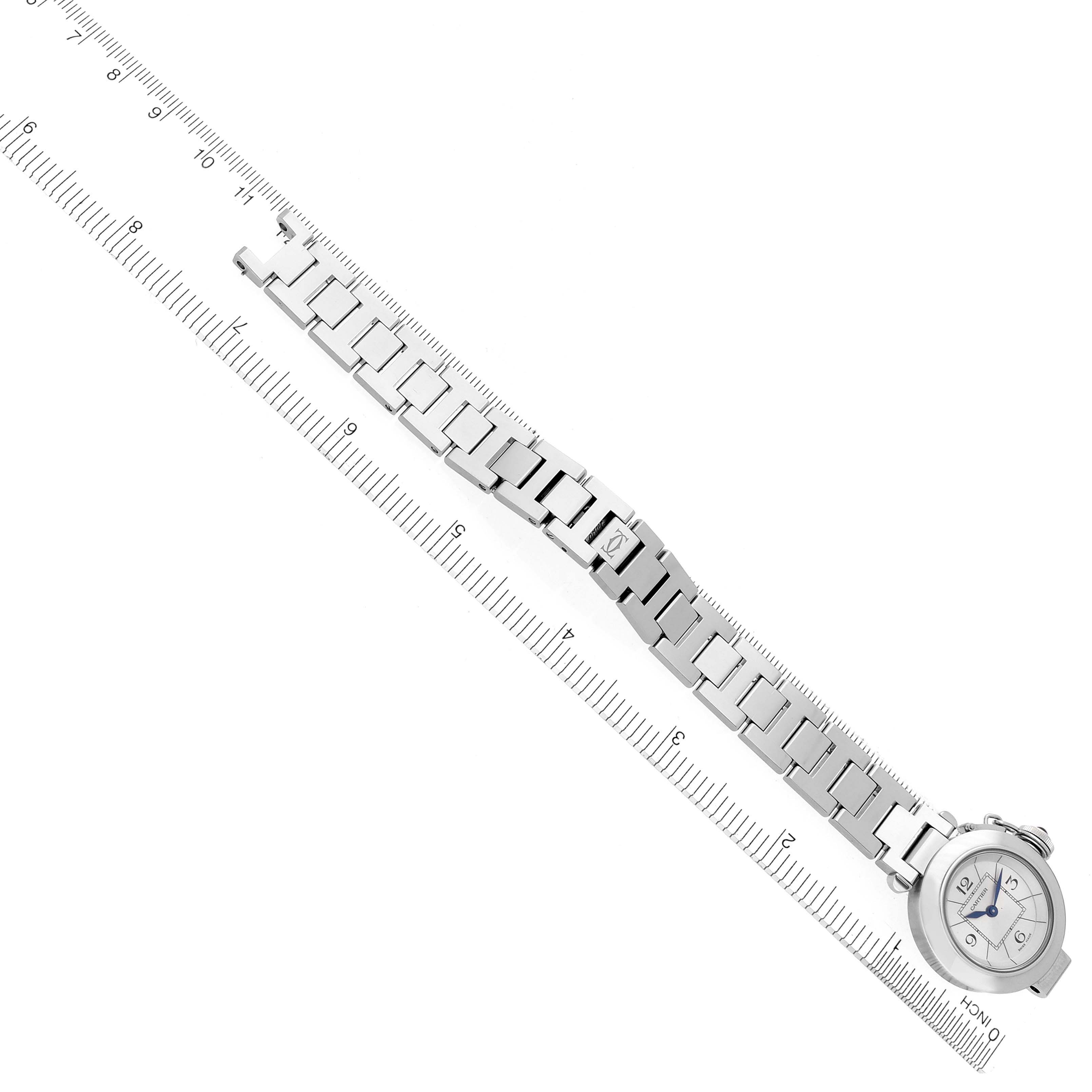 The image shows an overhead view of a Cartier Pasha W3140007 Women's Stainless Steel Silver Dial W3140007 Women's Stainless Steel Silver Dial watch with its bracelet extended alongside a ruler.