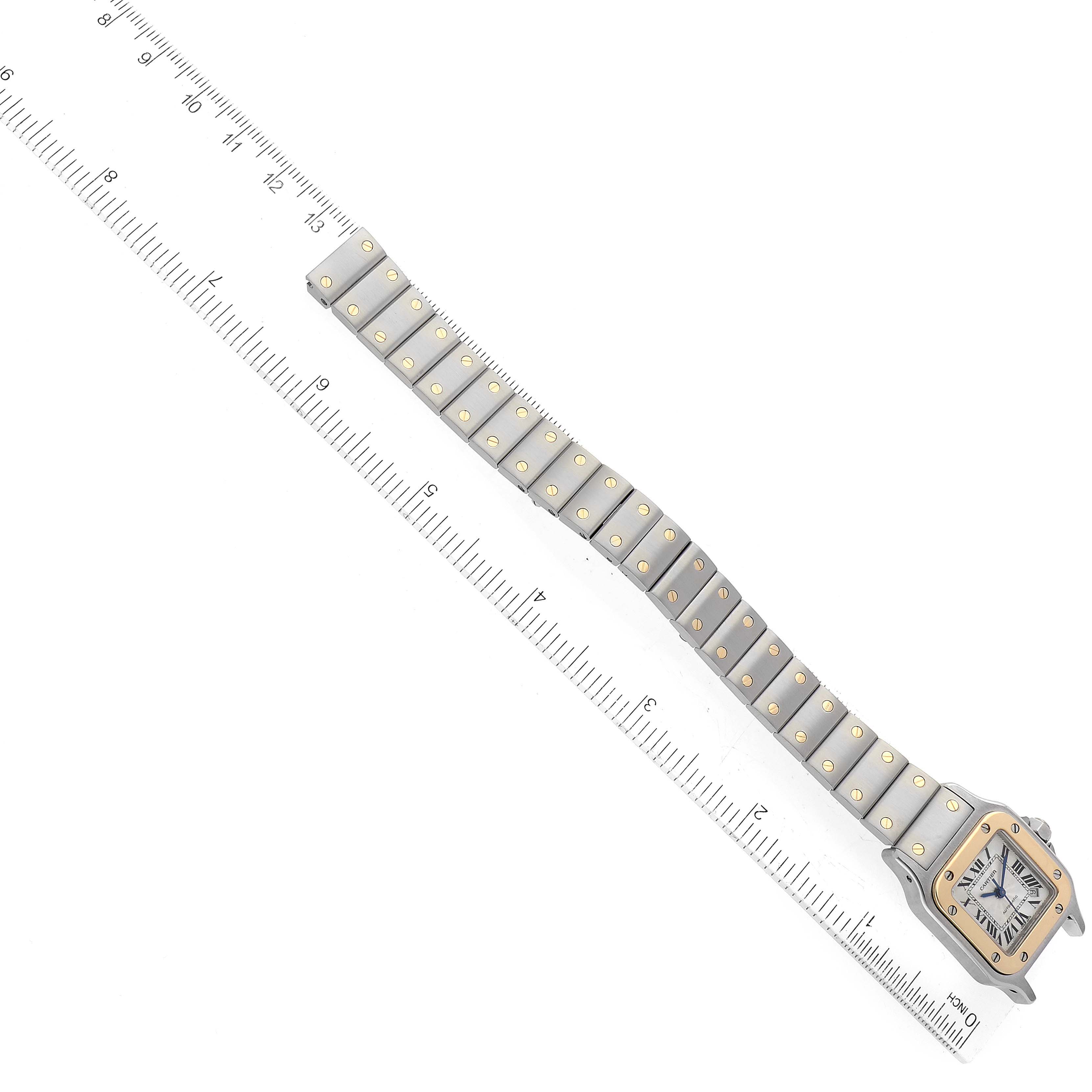 The image shows a Cartier Santos W20057C4 Women's Steel and Gold (two tone) Silver Dial W20057C4 Women's Steel and Gold (two tone) Silver Dial watch laid flat with its band extended alongside a ruler for measurement.