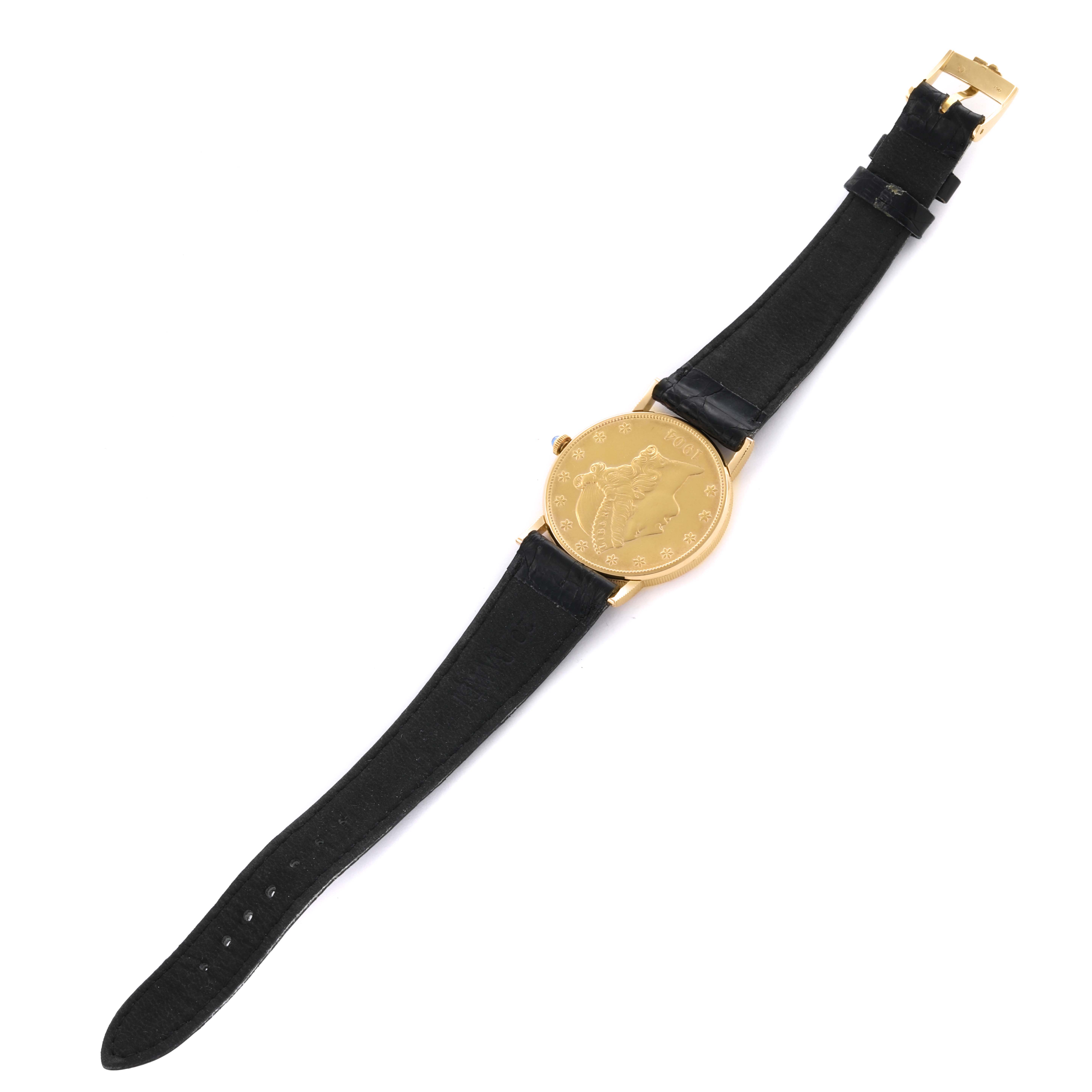 The Coin Watch by Corum is shown from a top-down angle, displaying the entire watch face and black leather strap.