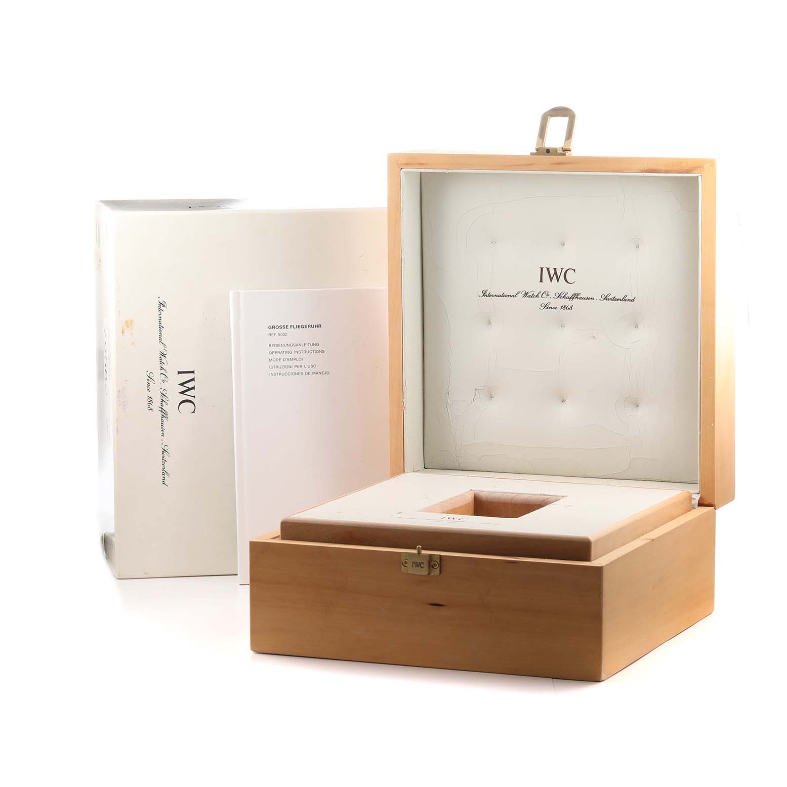 The image shows an open IWC Pilot IW500201 Men's Stainless Steel Black Dial watch box at an angle, alongside its outer packaging and a booklet.