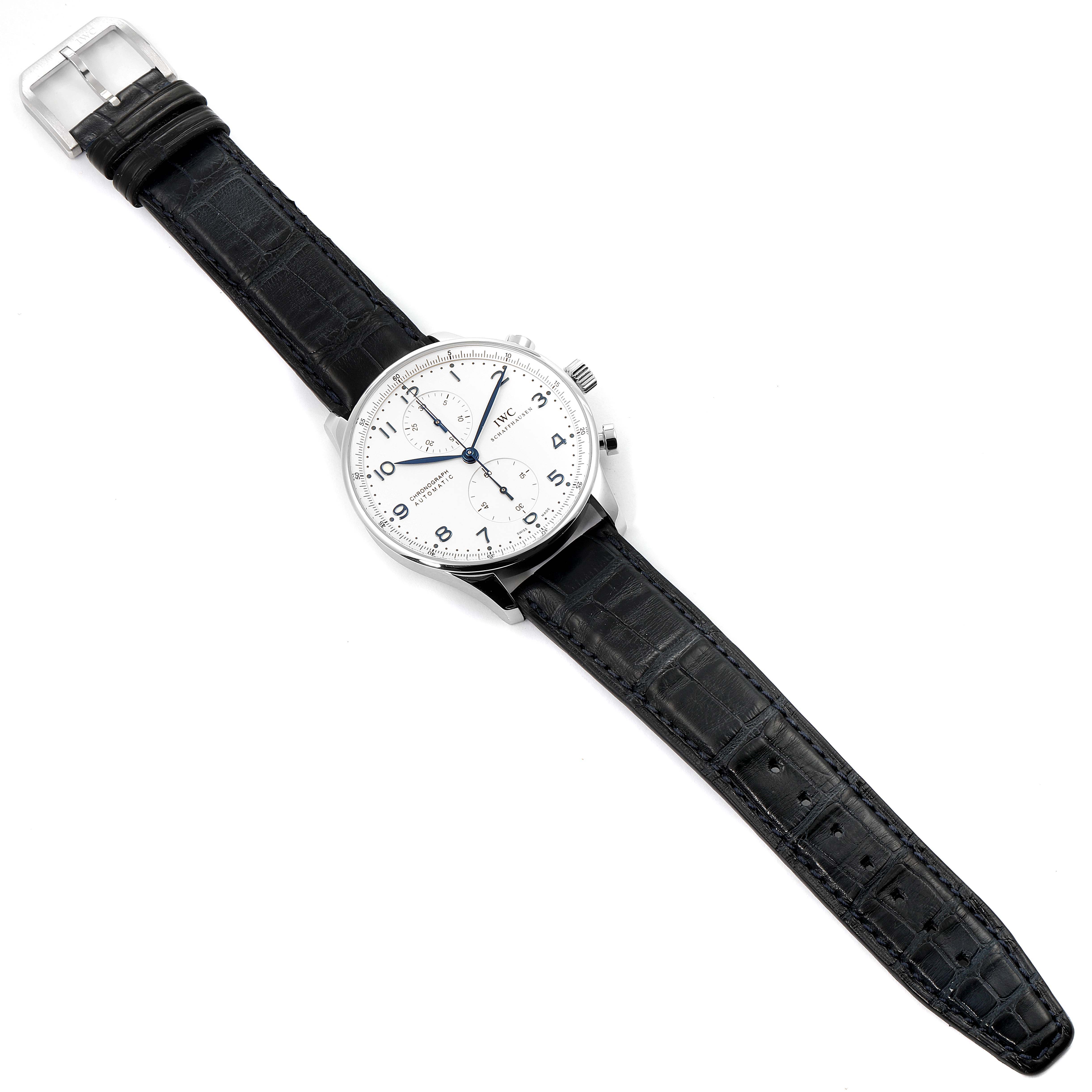 This Portuguese model by IWC is shown from a top-down angle, revealing the entire watch and its black leather strap.
