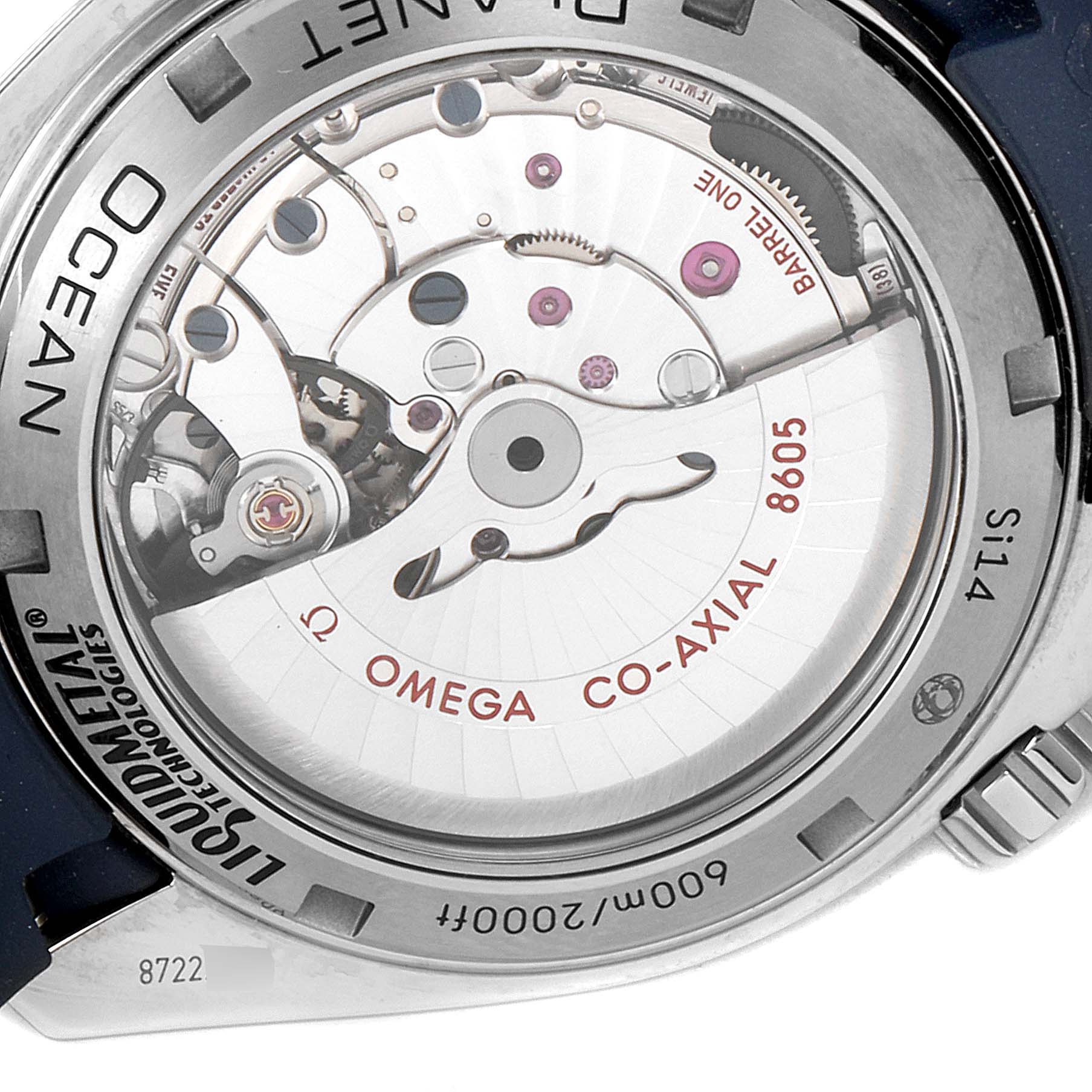 The image shows the backside of the Omega Planet Ocean 232.92.44.22.03.001 Men's Stainless Steel Blue Dial 232.92.44.22.03.001 Men's Stainless Steel Blue Dial watch, highlighting the exposed movement and engravings on the case back.