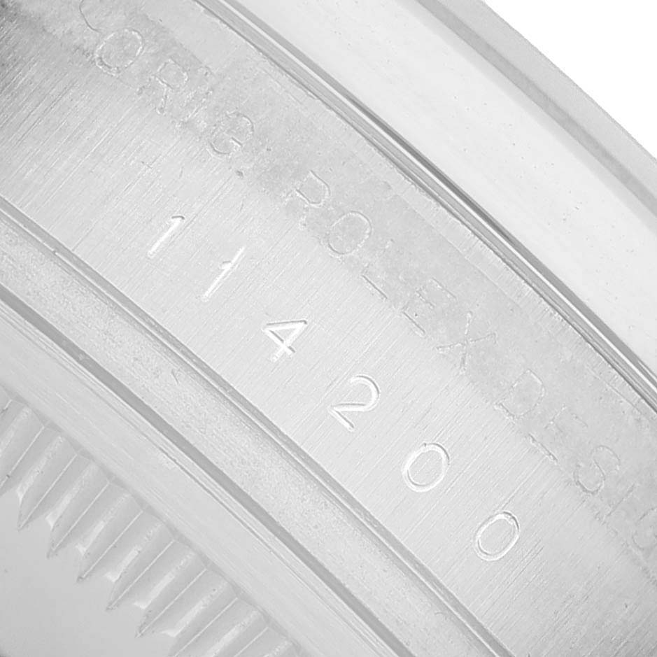 The image shows a close-up of the engraved model number on the Rolex Air-King 114200 Men's Stainless Steel White Dial watch casing.