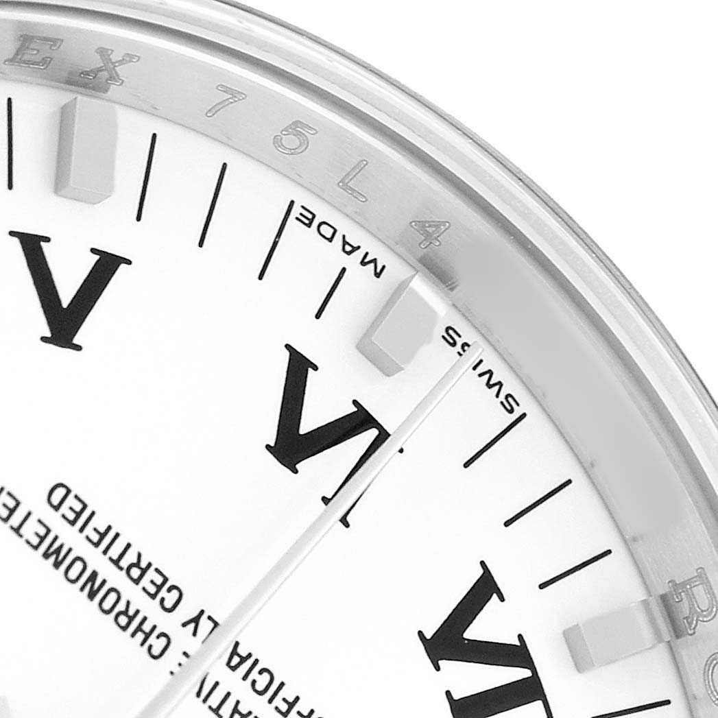 The image shows a close-up of the Rolex Air-King 114200 Men's Stainless Steel White Dial watch face, highlighting the VI marker and part of the engraved bezel.