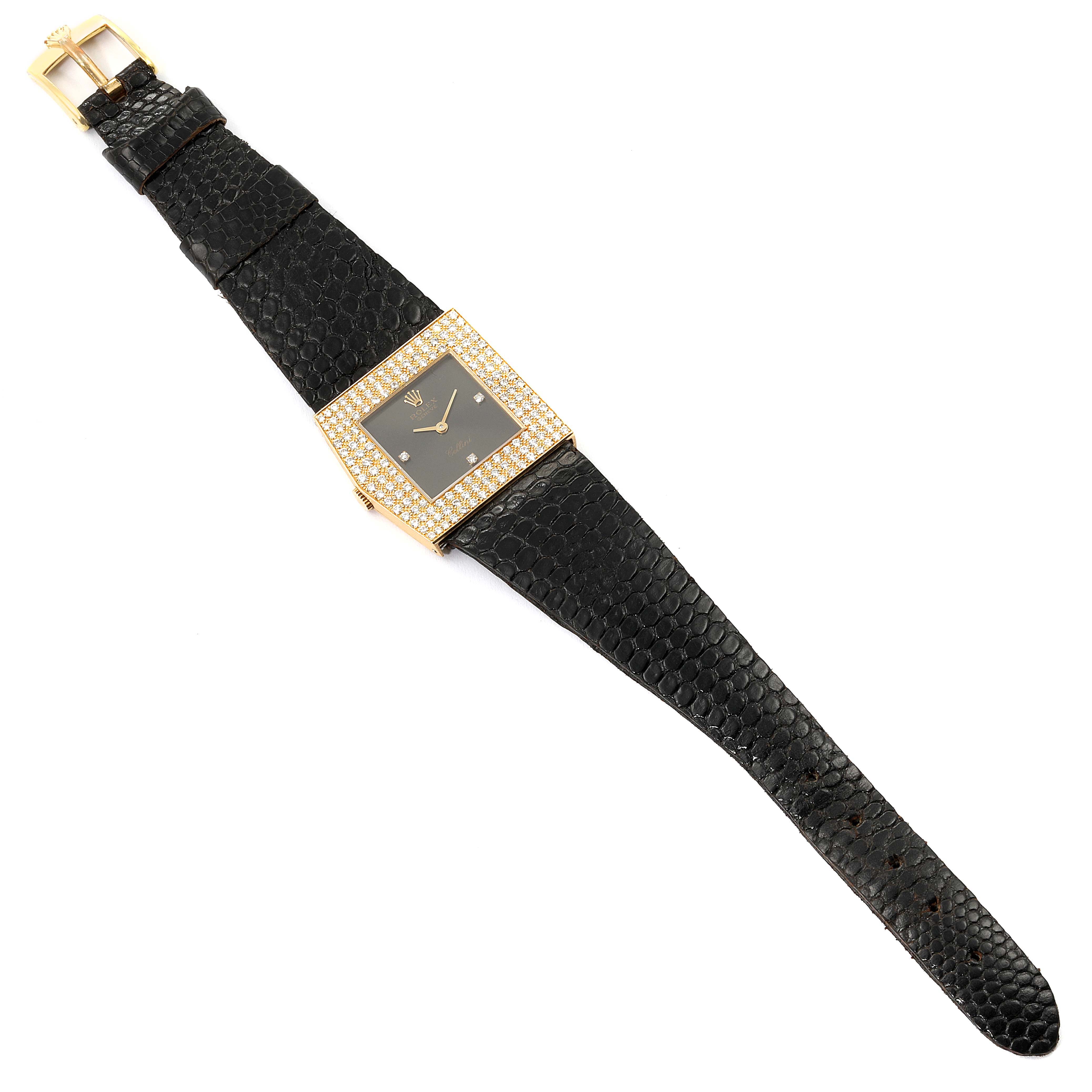 The Rolex Cellini 4031 Men's Yellow Gold Grey Dial 4031 Men's Yellow Gold Grey Dial watch is shown from a top-down angle displaying its black strap, square face, and gemstone-encrusted bezel.