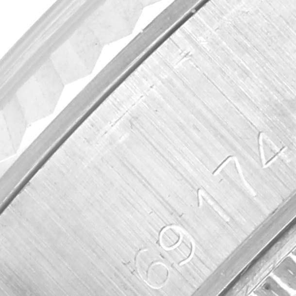 This image shows a close-up of the side of a Rolex Date 69174 Women's Stainless Steel Silver Dial 69174 Women's Stainless Steel Silver Dial watch, focusing on the band and engraved details.