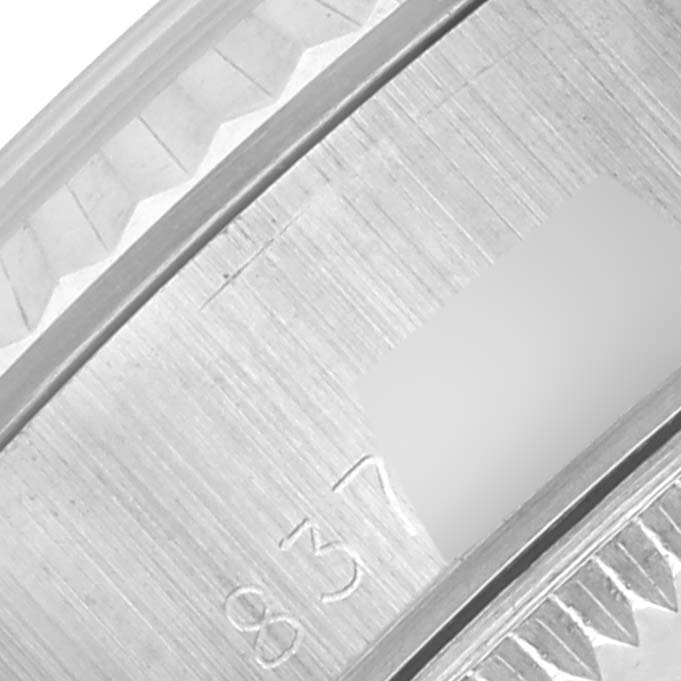 The image shows a close-up of the side of a Rolex Date 69174 Women's Stainless Steel Silver Dial 69174 Women's Stainless Steel Silver Dial model, highlighting the serial engraving on the case.