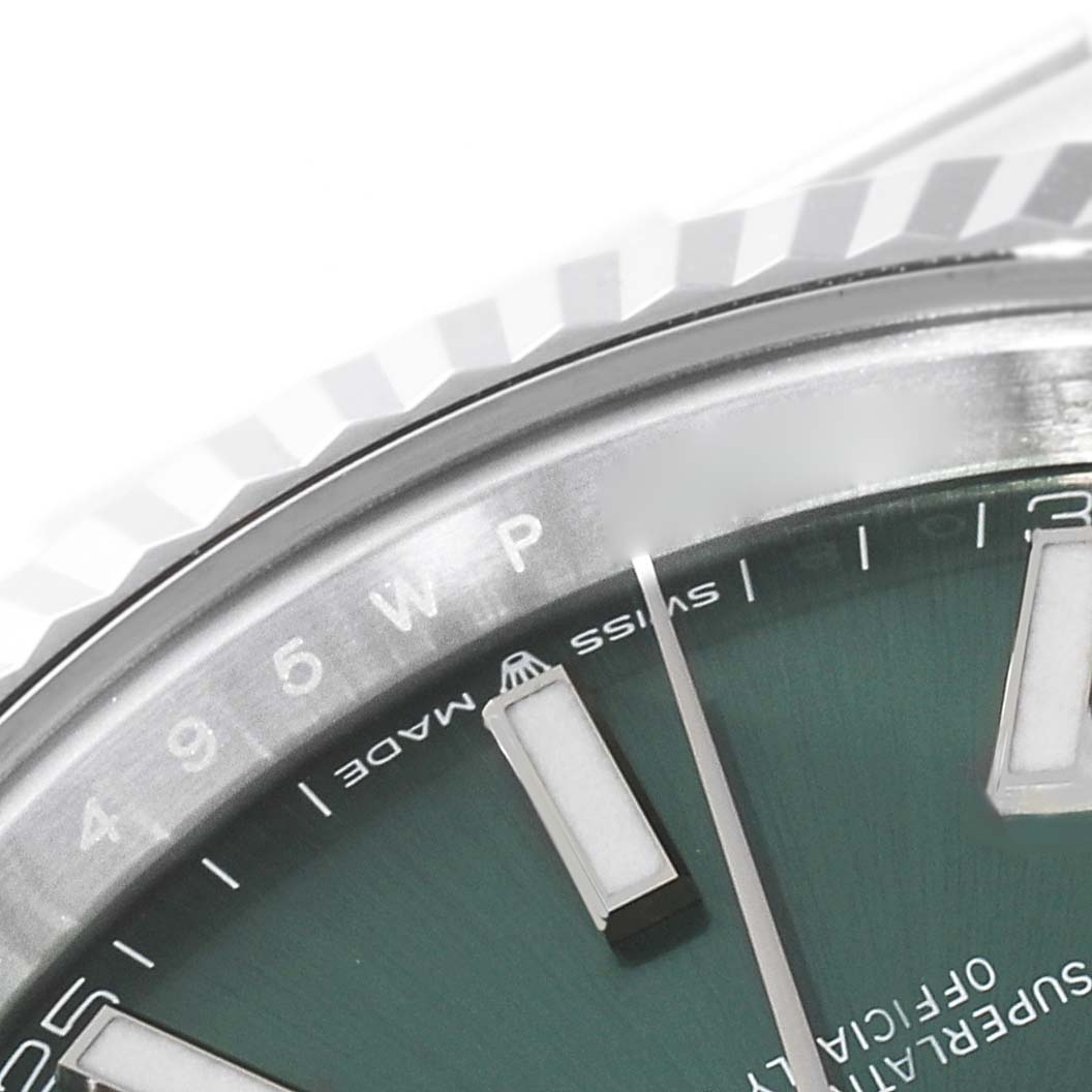 This close-up image shows the upper half of the Rolex Datejust 41 126334 Men's Stainless Steel Green Dial 126334 Men's Stainless Steel Green Dial watch dial and part of the bezel.