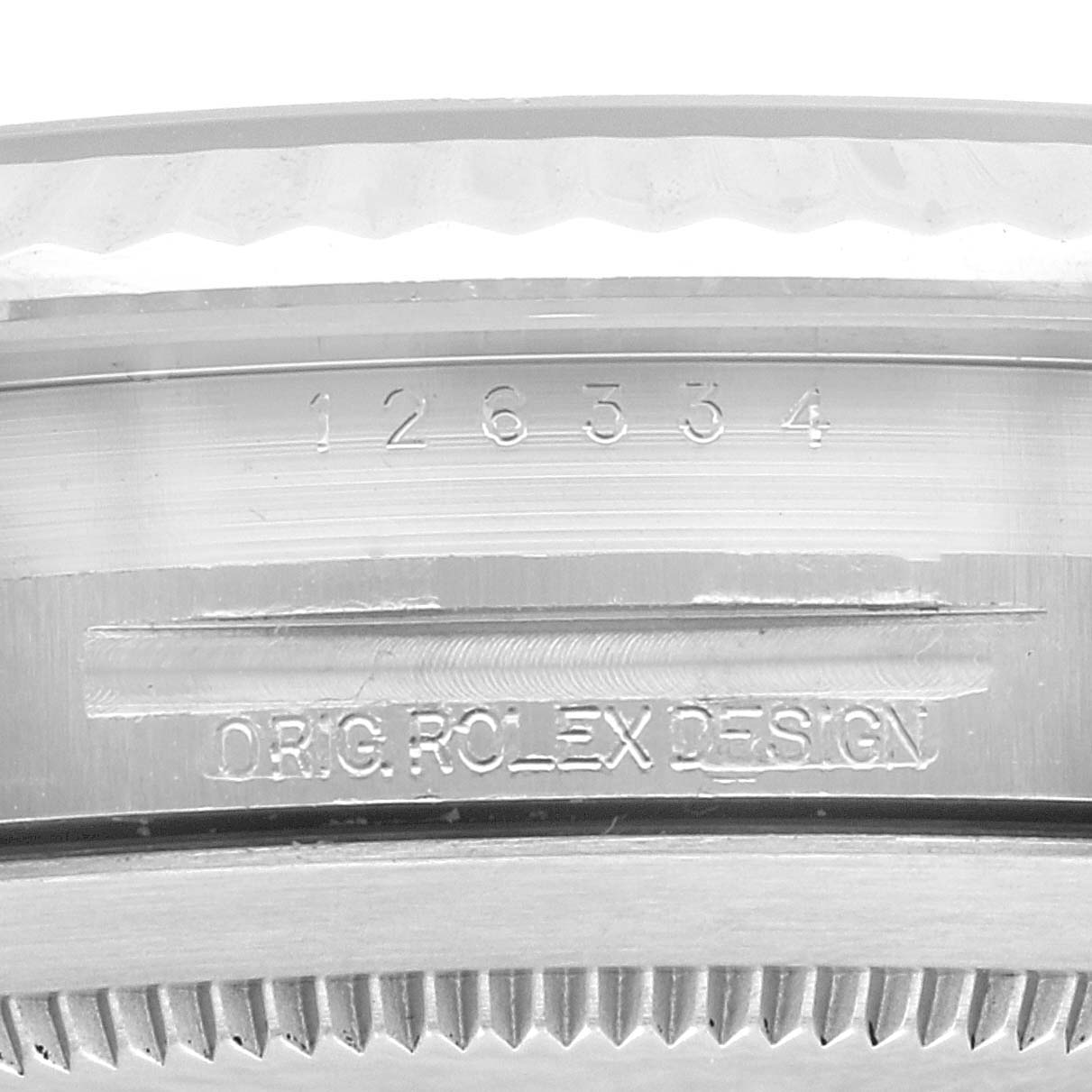 This image shows a close-up of the serial number and "ORIG. ROLEX DESIGN" engraving on the case of a Rolex Datejust 41 126334 Men
s Stainless Steel Silver Dial 126334 Men
s Stainless Steel Silver Dial watch.