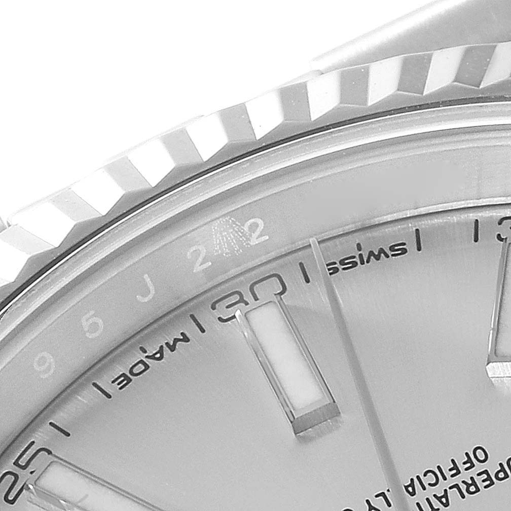 This close-up image of the Rolex Datejust 41 126334 Men
s Stainless Steel Silver Dial 126334 Men
s Stainless Steel Silver Dial watch shows part of the bezel, dial, and markers.