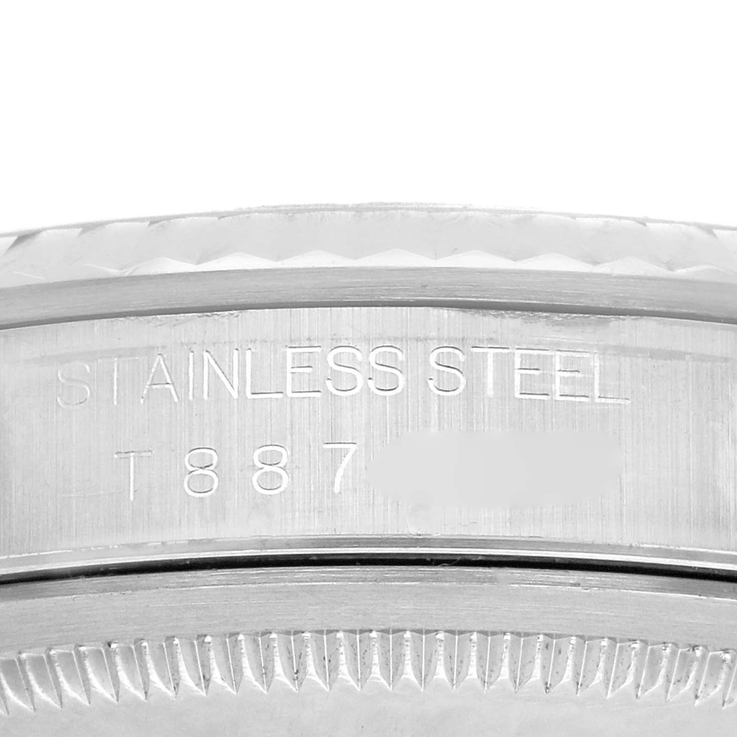 The image shows a close-up of the side of the Rolex Datejust 16234 Men
s Stainless Steel Blue Dial 16234 Men
s Stainless Steel Blue Dial, highlighting its stainless steel bezel and engraved details.