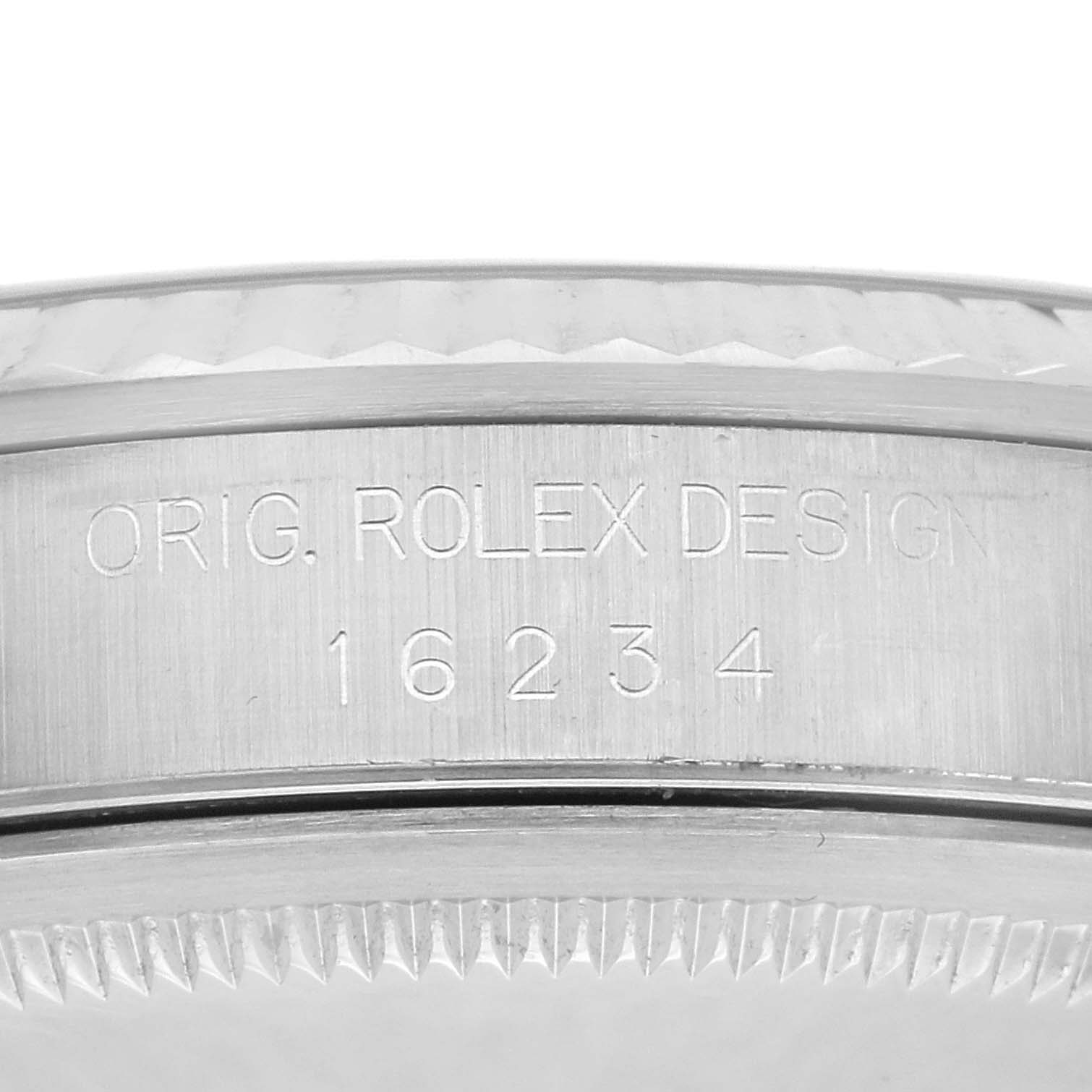 This image shows a close-up of the side of a Rolex Datejust 16234 Men
s Stainless Steel Blue Dial 16234 Men
s Stainless Steel Blue Dial, highlighting the engraved model number and part of the fluted bezel.