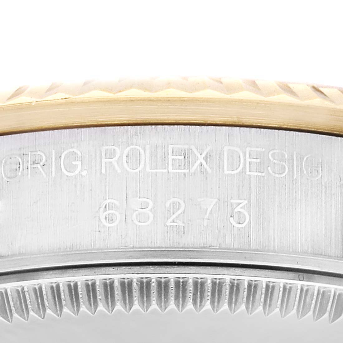 This image shows a close-up of the model number and parts of the bezel and case of a Rolex Mid-Size 68273 Women
s Steel and Gold (two tone) Champagne Dial 68273 Women
s Steel and Gold (two tone) Champagne Dial watch, model 68273.