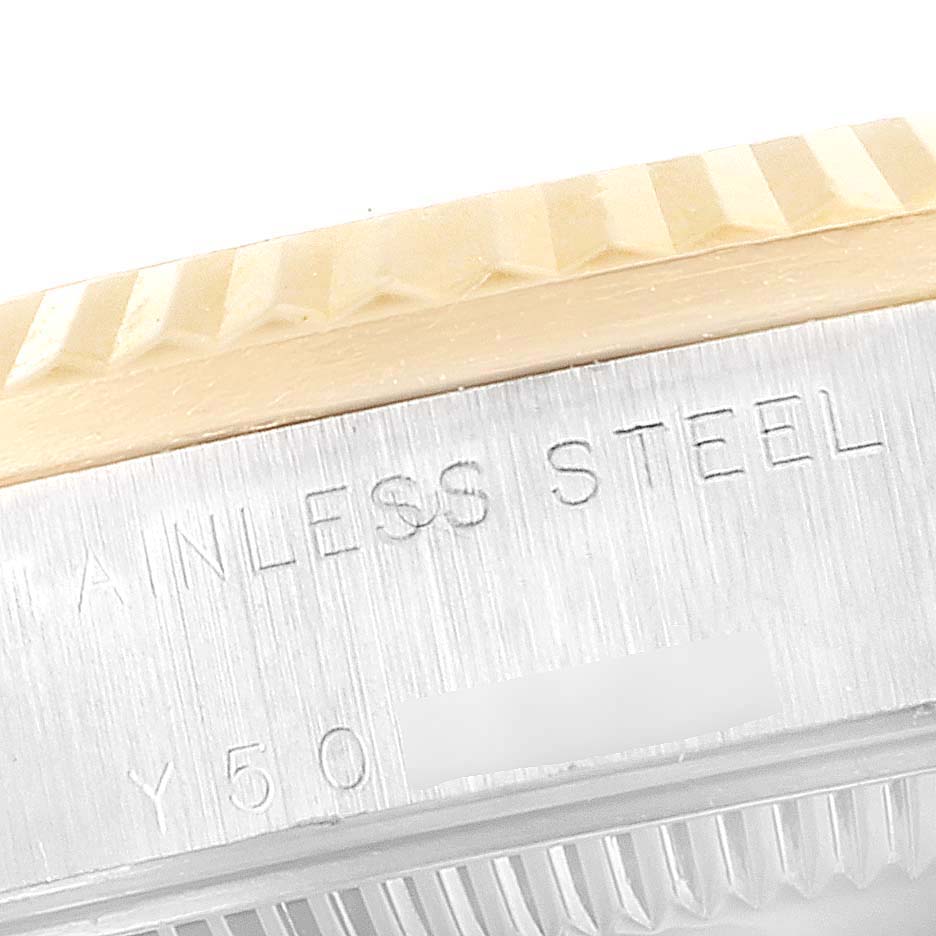 This close-up angle shows the stainless steel case and fluted bezel of a Mid-Size Rolex watch.