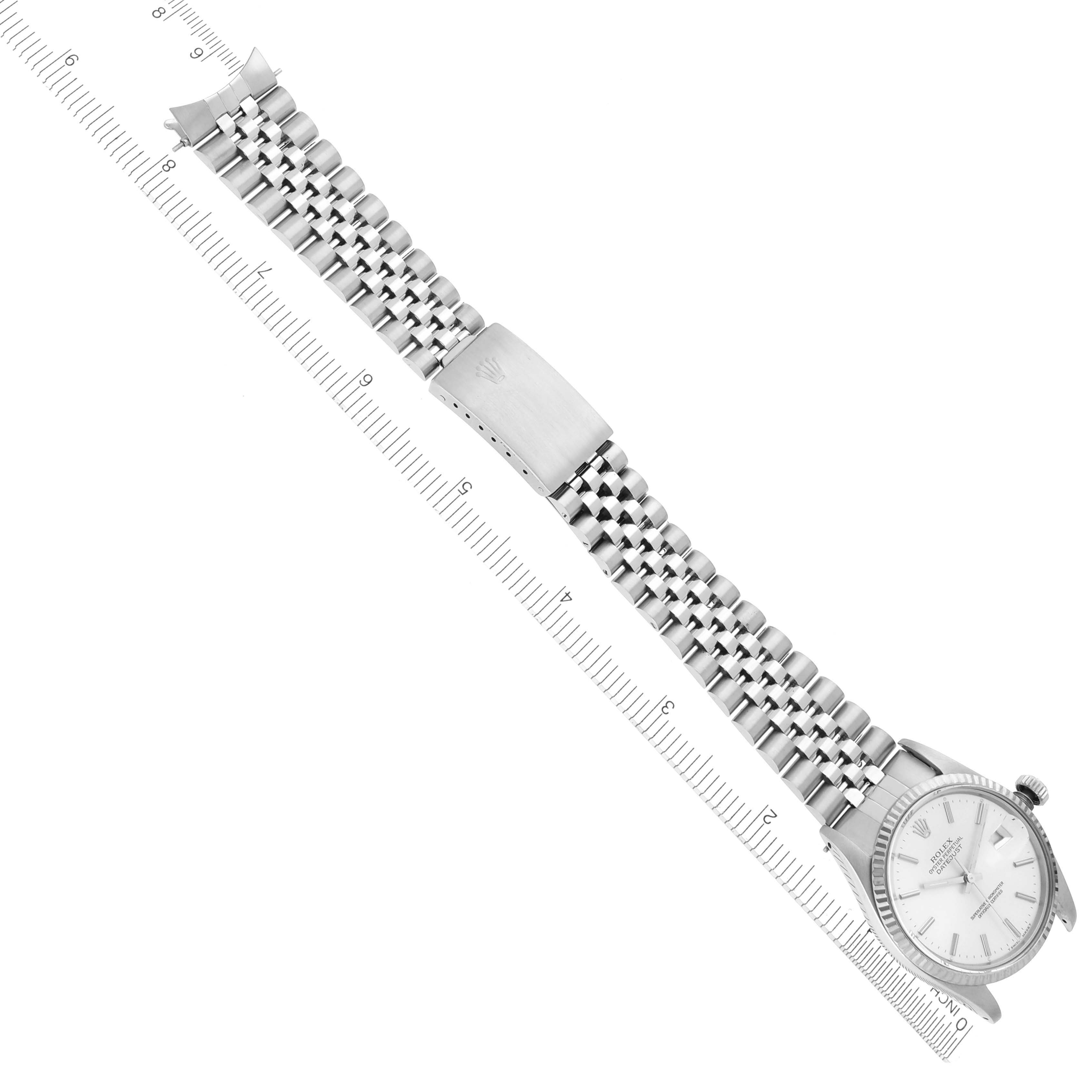 The image shows a Rolex Datejust 16014 Men's Stainless Steel Silver Dial 16014 Men's Stainless Steel Silver Dial watch from a top-down angle, displaying the face, bezel, and full bracelet with a ruler for scale.