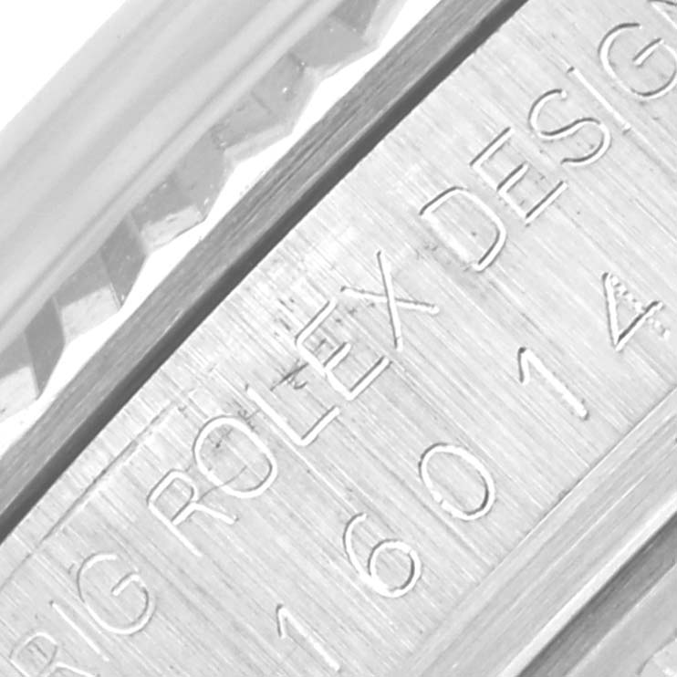 The image shows a close-up of the fluted bezel and engraving on the side of a Rolex Datejust 16014 Men's Stainless Steel Silver Dial 16014 Men's Stainless Steel Silver Dial watch.