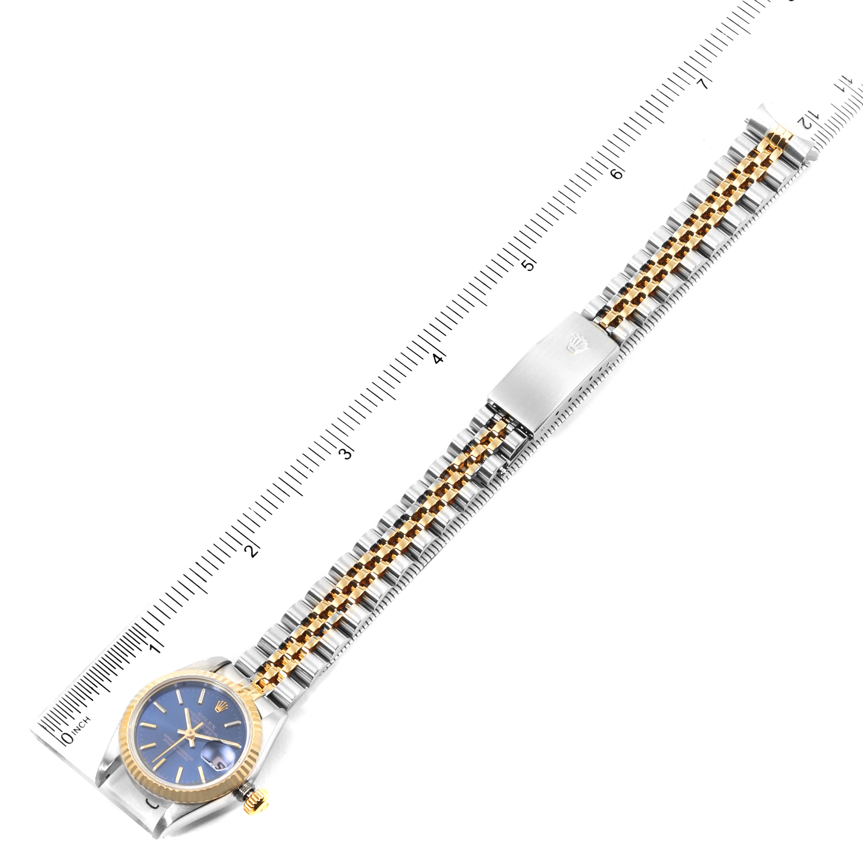 The image shows a Rolex Datejust 79173 Women's Steel and Gold (two tone) Blue Dial 79173 Women's Steel and Gold (two tone) Blue Dial watch from a top-down angle, with a focus on the watch face, bracelet, and clasp.