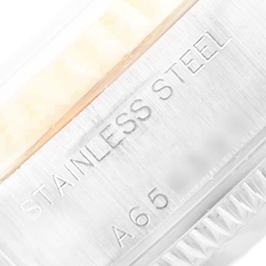 This image shows a close-up of the case and bezel of a Rolex Datejust 79173 Women's Steel and Gold (two tone) Blue Dial 79173 Women's Steel and Gold (two tone) Blue Dial watch, focusing on the "STAINLESS STEEL" engraving.