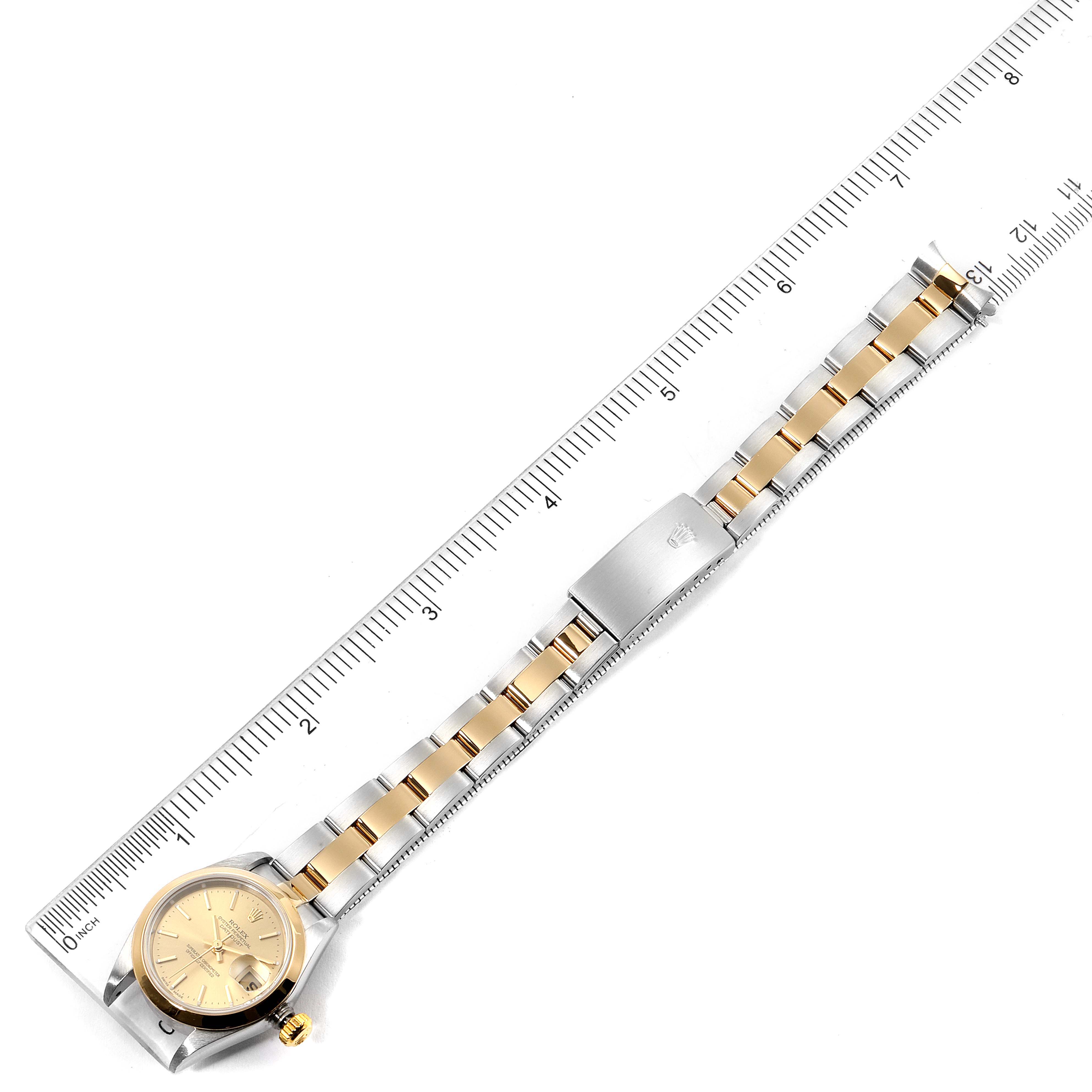 The image shows a Rolex Datejust 79163 Women's Steel and Gold (two tone) Champagne Dial 79163 Women's Steel and Gold (two tone) Champagne Dial watch laid flat with a ruler measuring its length, displaying the face and the bracelet.