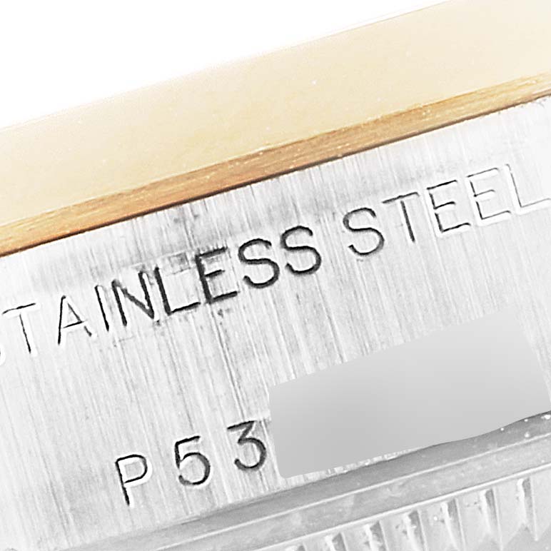 The image shows a close-up view of the side of a Rolex Datejust 79163 Women's Steel and Gold (two tone) Champagne Dial 79163 Women's Steel and Gold (two tone) Champagne Dial watch, highlighting the "STAINLESS STEEL" engraving and part of the serial number.