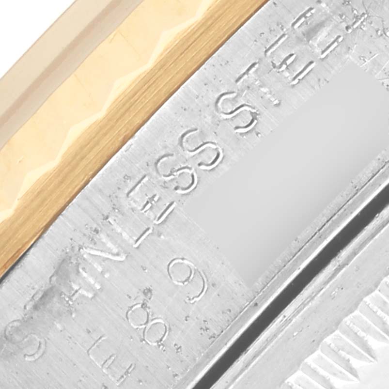 The image shows a close-up of the Rolex Datejust 16233 Men
s Stainless Steel White Dial 16233 Men
s Stainless Steel White Dial watch
s fluted bezel and part of the engraved interior.