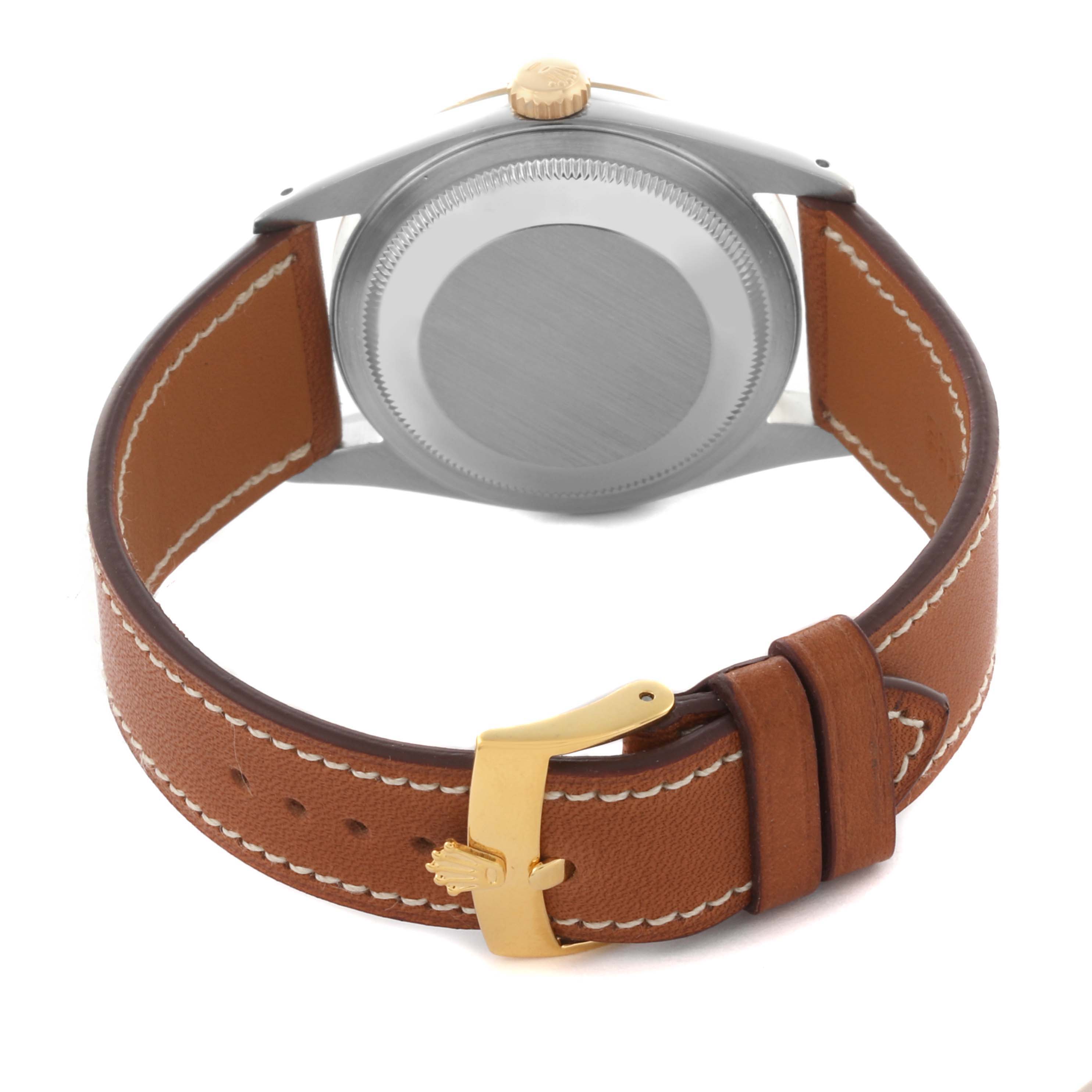 The image shows the back of a Rolex Datejust 16233 Men
s Stainless Steel White Dial 16233 Men
s Stainless Steel White Dial watch, featuring the case back, a brown leather strap, and a gold buckle.