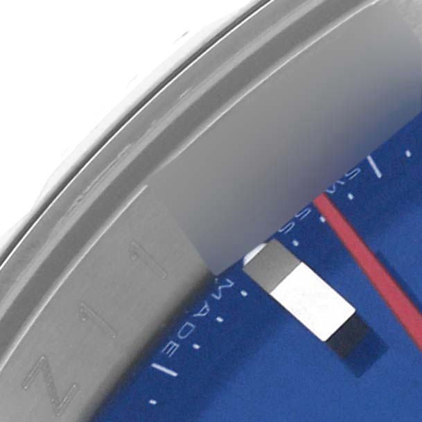 The image shows a close-up of the bezel, dial, and part of the hand of a Rolex Turn-o-Graph 116264 Men's Stainless Steel Blue Dial 116264 Men's Stainless Steel Blue Dial watch.