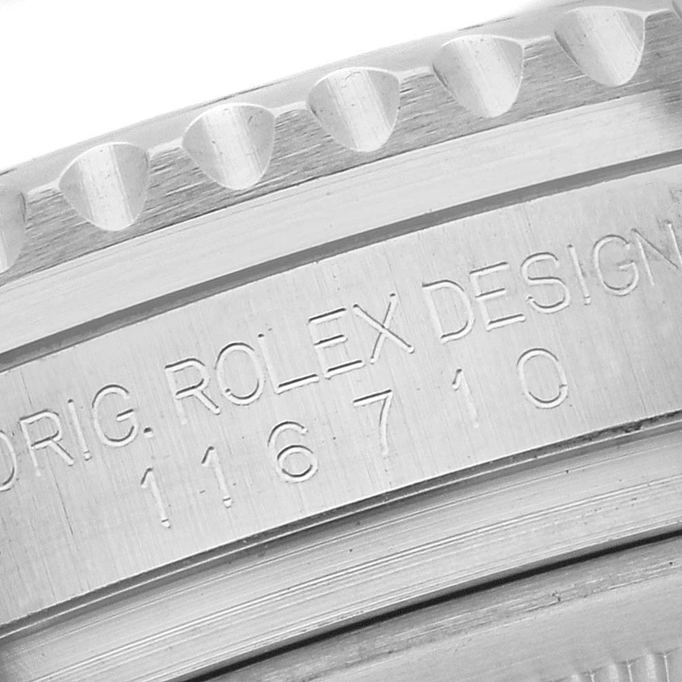 This close-up image shows the engraved model number and the bezel of a Rolex GMT-Master 116710LN Men
s Stainless Steel Black Dial 116710LN Men
s Stainless Steel Black Dial watch.